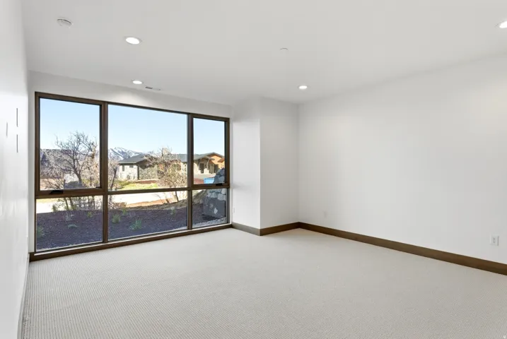 Spare room with light carpet and recessed lighting