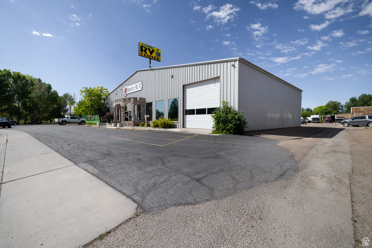 View of building exterior featuring uncovered parking