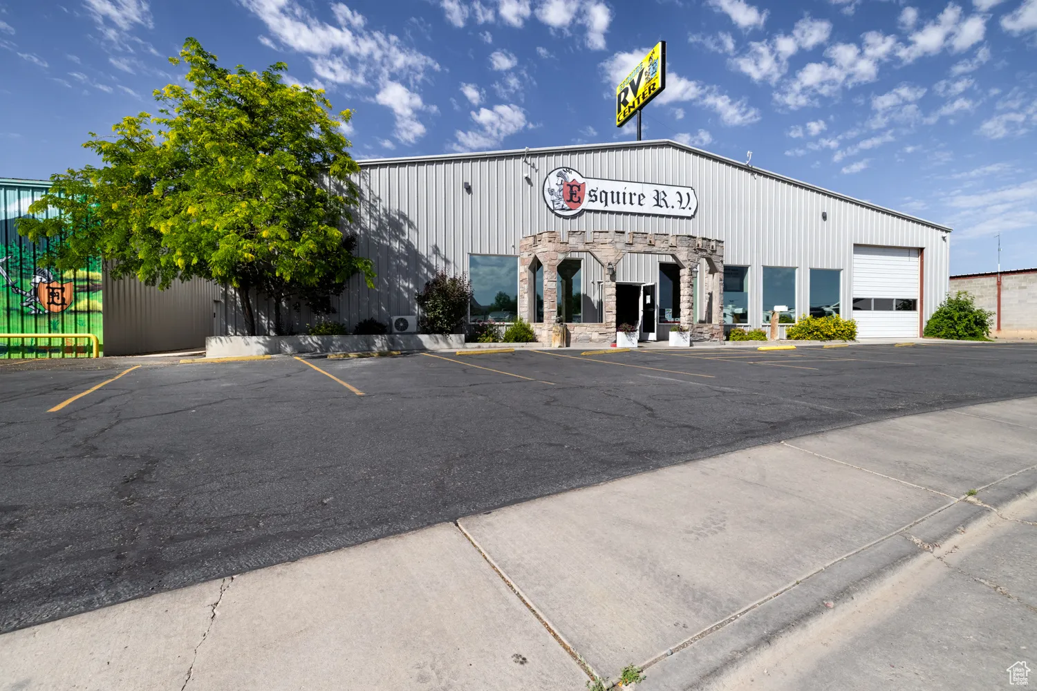 View of commercial property with uncovered parking