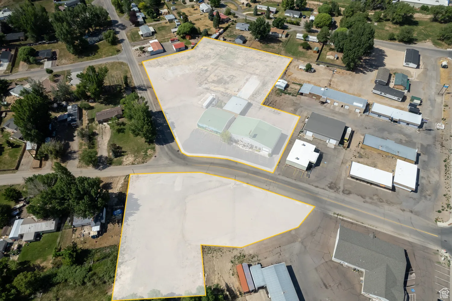 Aerial overview of property's location featuring property parcel outlined and nearby suburban area