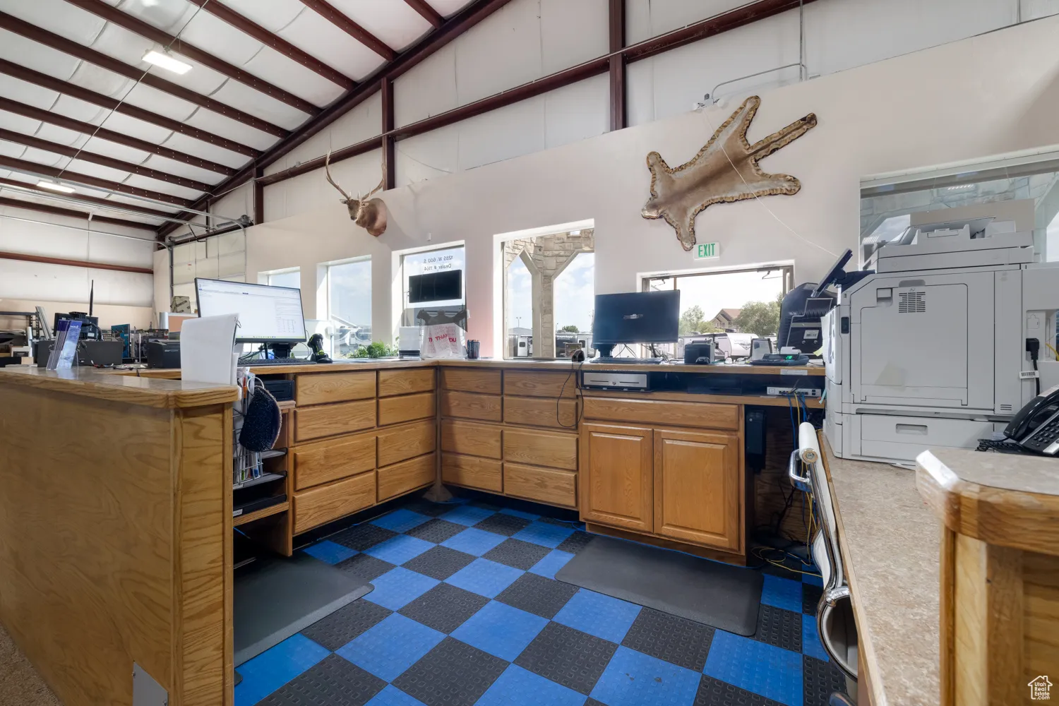 Misc room featuring high vaulted ceiling and an office area
