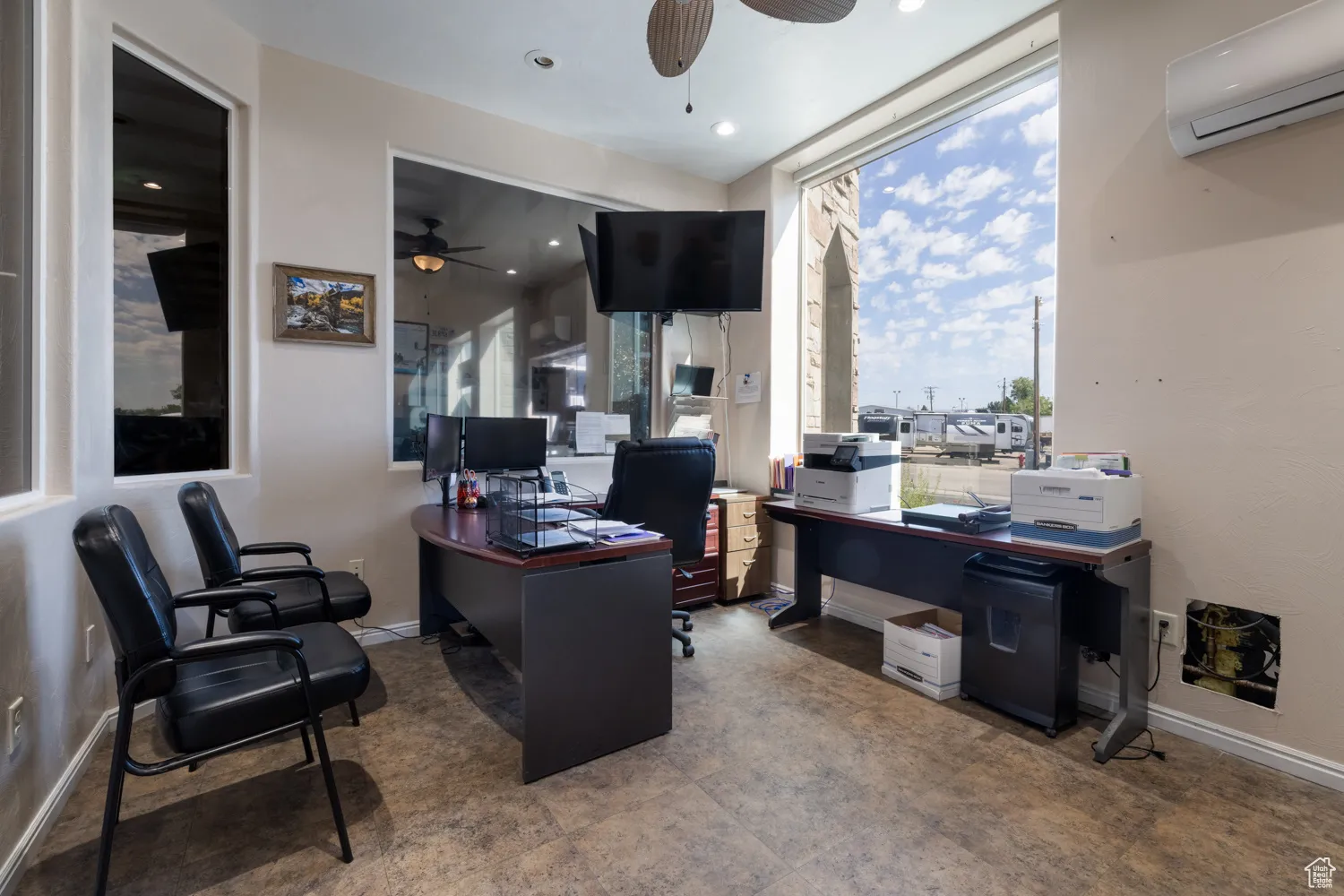 Home office featuring a ceiling fan, a wall unit AC, and recessed lighting