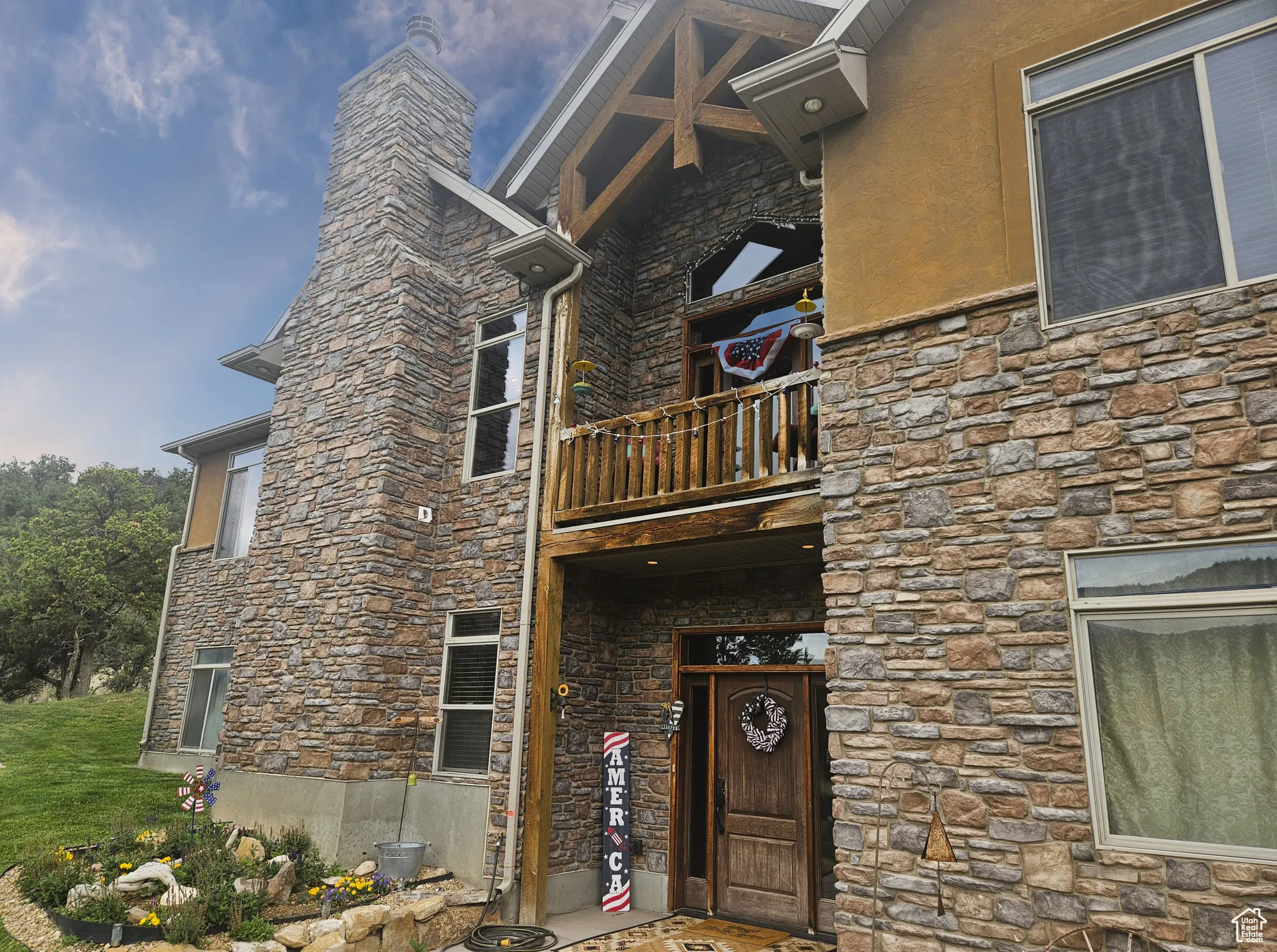 The home’s rustic stone façade blends seamlessly with the natural surroundings, offering timeless character and mountain-inspired charm.
