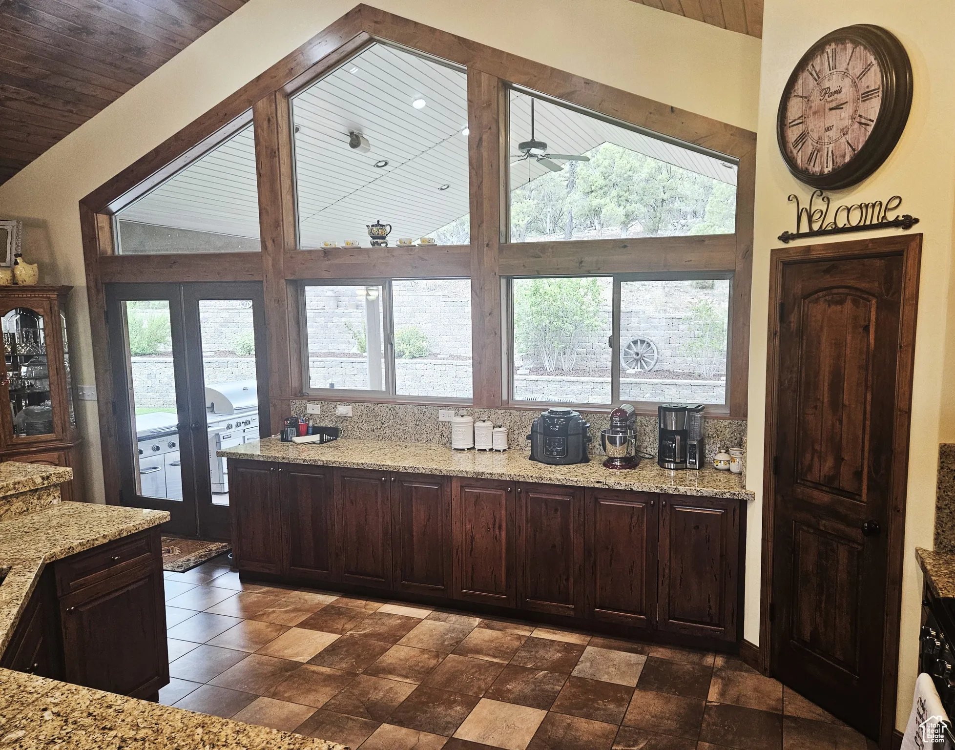Bright and spacious, the kitchen’s expansive window wall invites natural light and fresh mountain air while providing direct access to the covered patio.