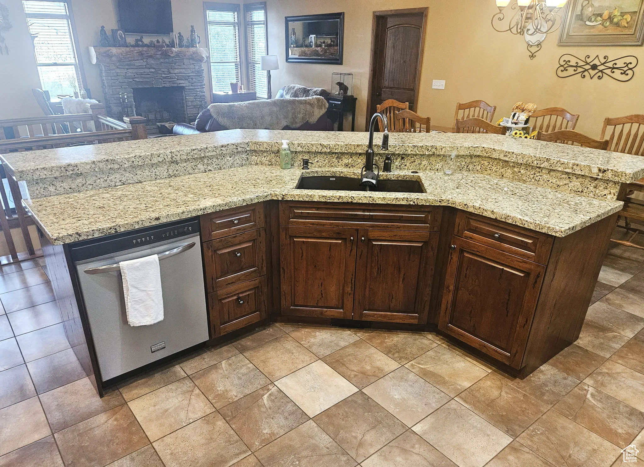 The spacious angled island is the heart of the kitchen, featuring integrated seating, a sink, and dishwasher for effortless entertaining and meal prep.