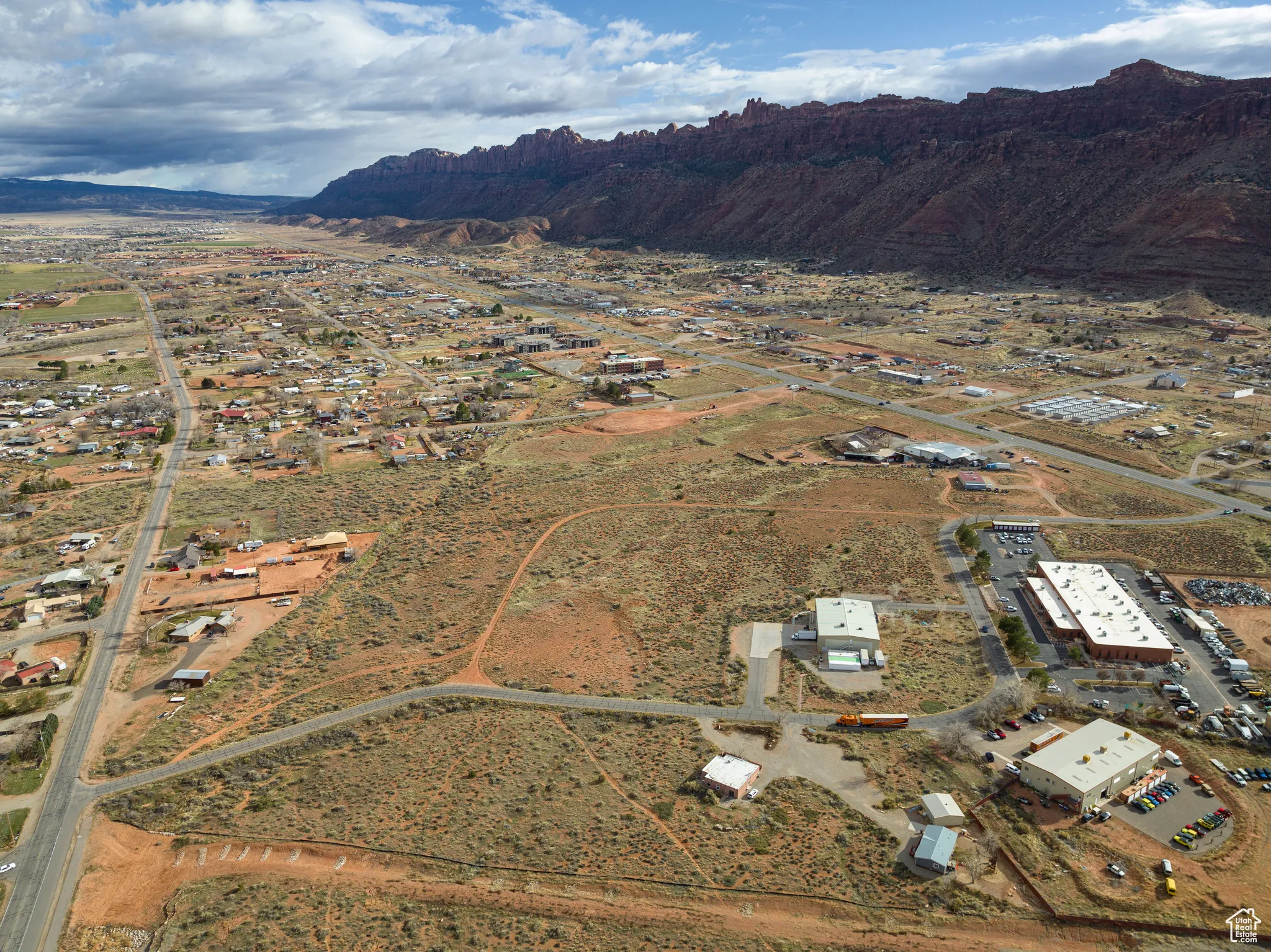 Aerial view of property's location with a mountainous background and rural landscape