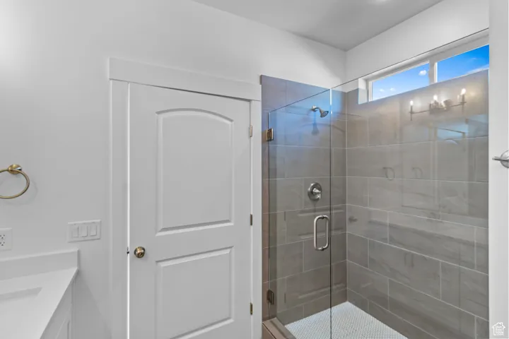 Full bathroom featuring a shower stall and vanity