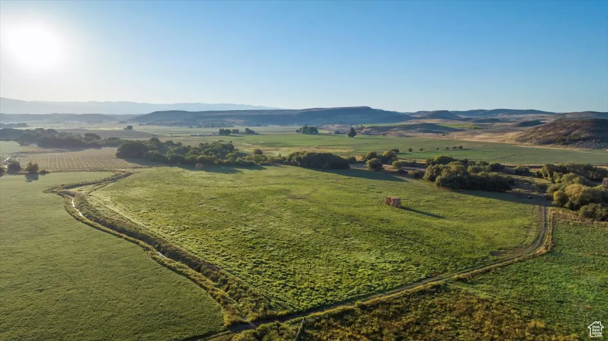 View of mountain backdrop with rural landscape