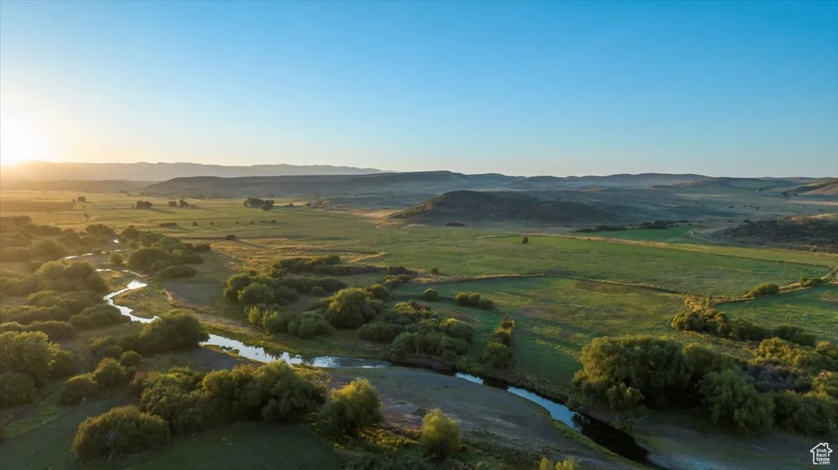 Aerial view of property and surrounding area featuring mountains and rural landscape