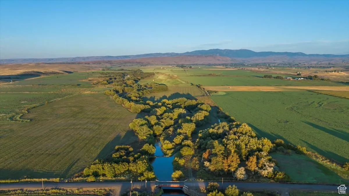 Aerial view of property's location featuring rural landscape and mountains