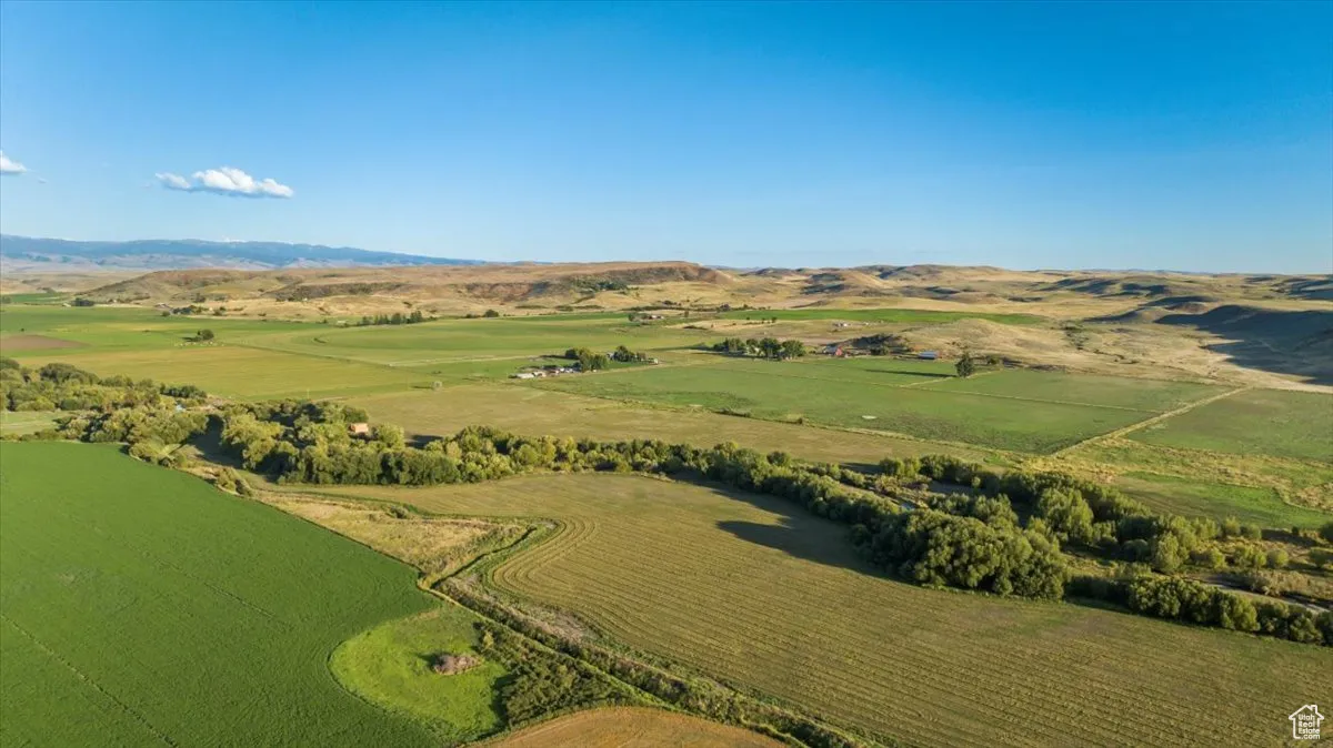 Aerial view of property's location with rural landscape and a mountain backdrop