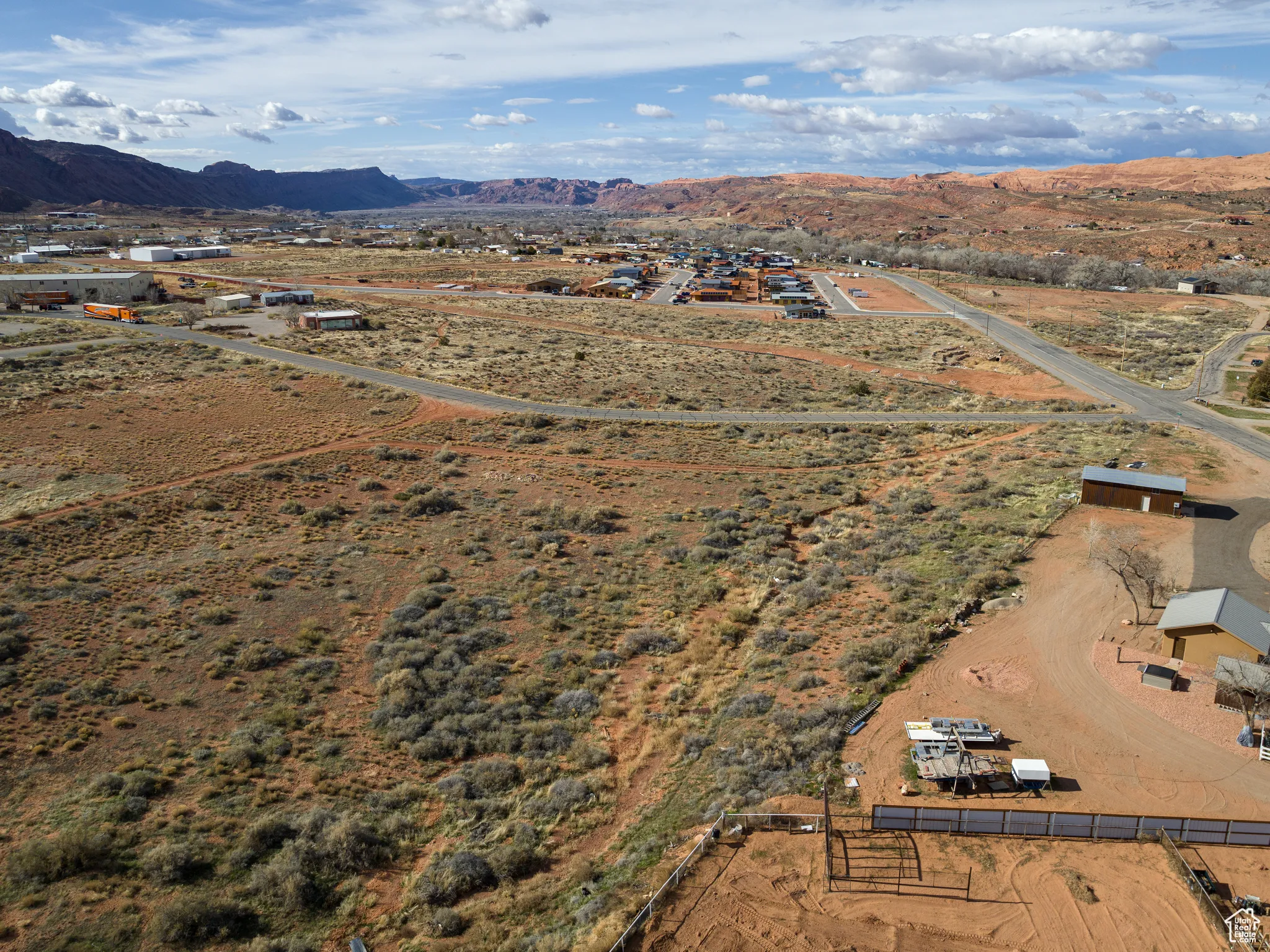 Aerial view of sparsely populated area with a mountainous background and a desert landscape