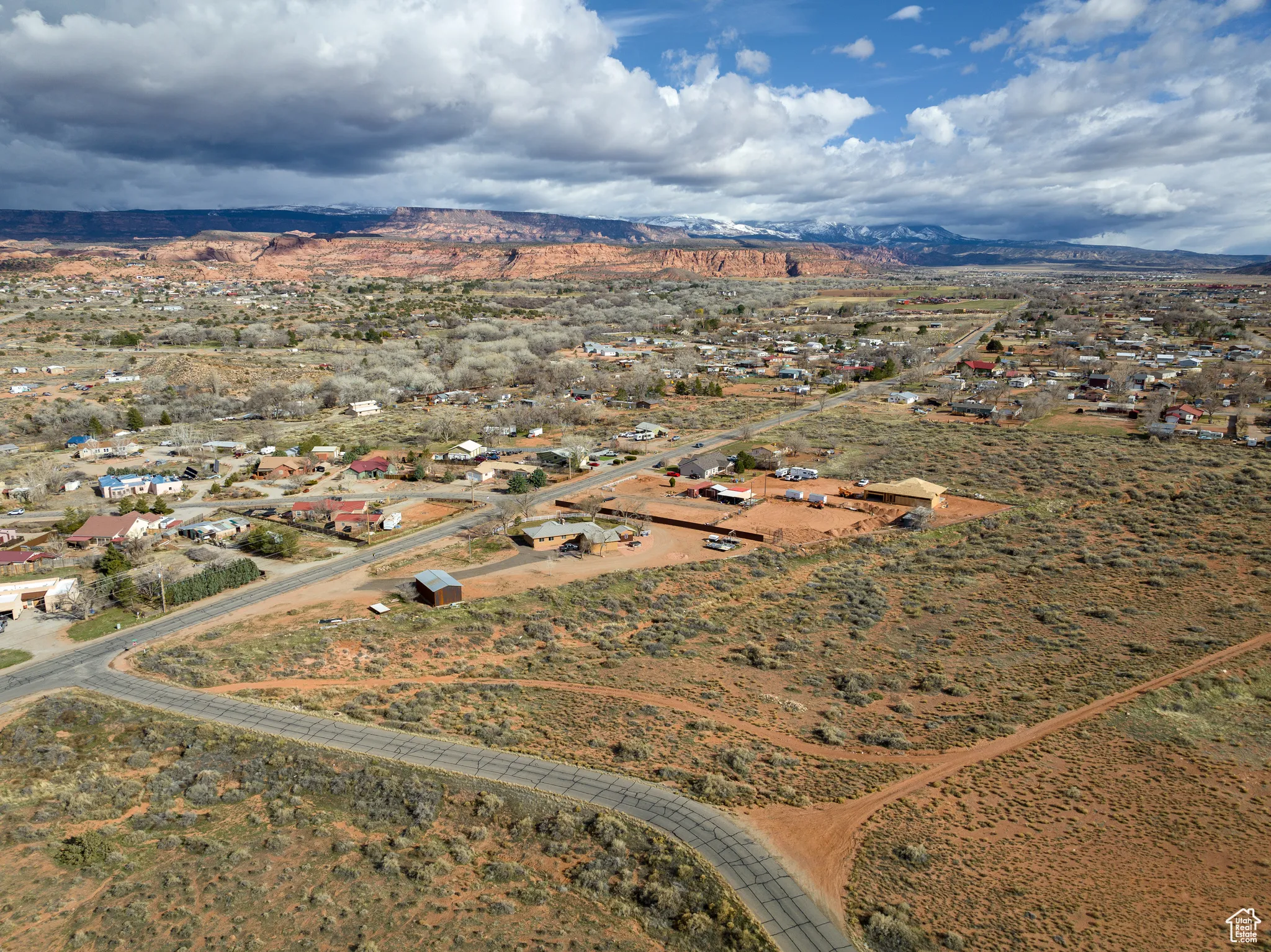 Aerial view of property and surrounding area with rural landscape and nearby suburban area