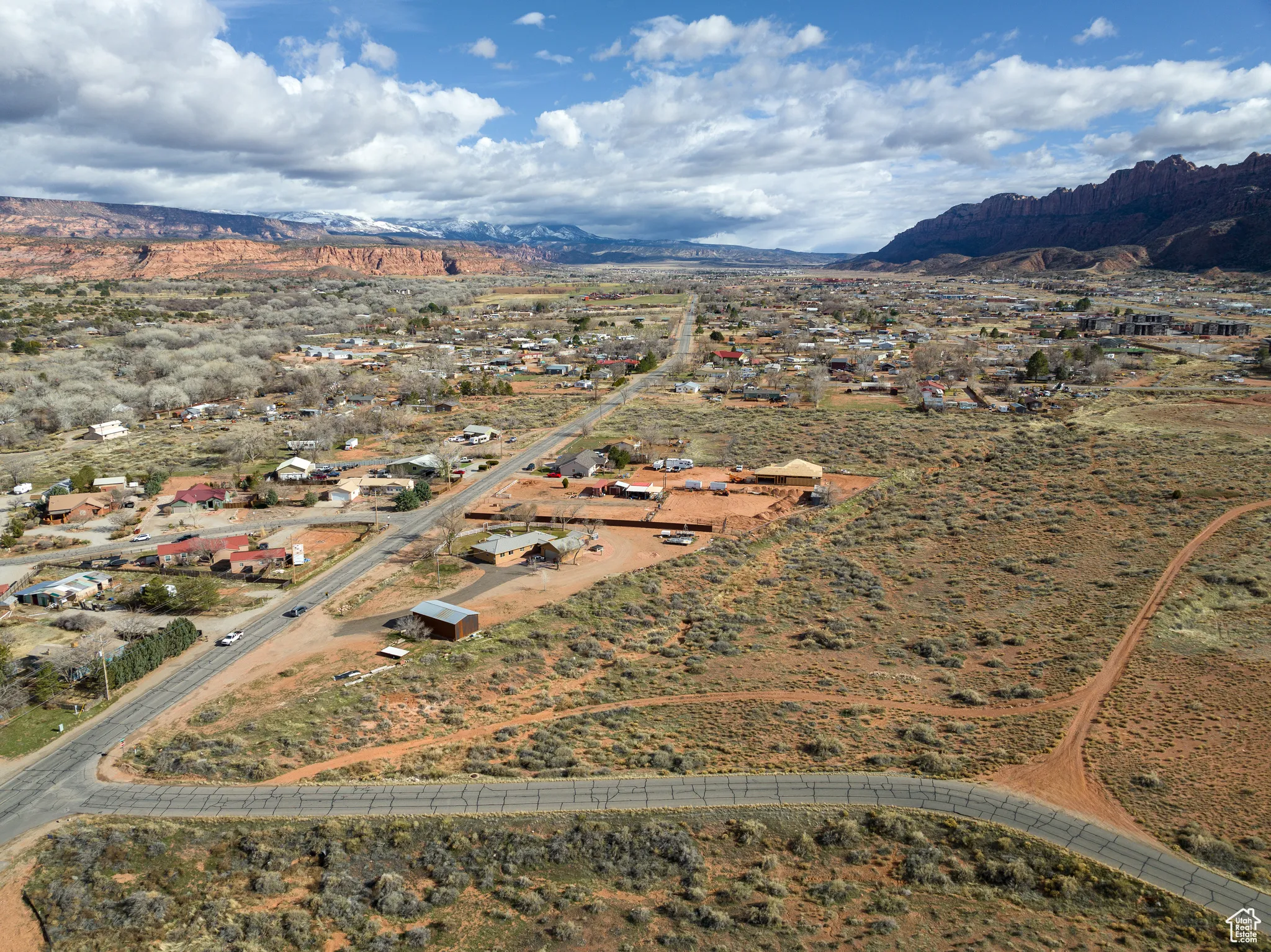 Aerial view of property and surrounding area with a mountainous background and rural landscape