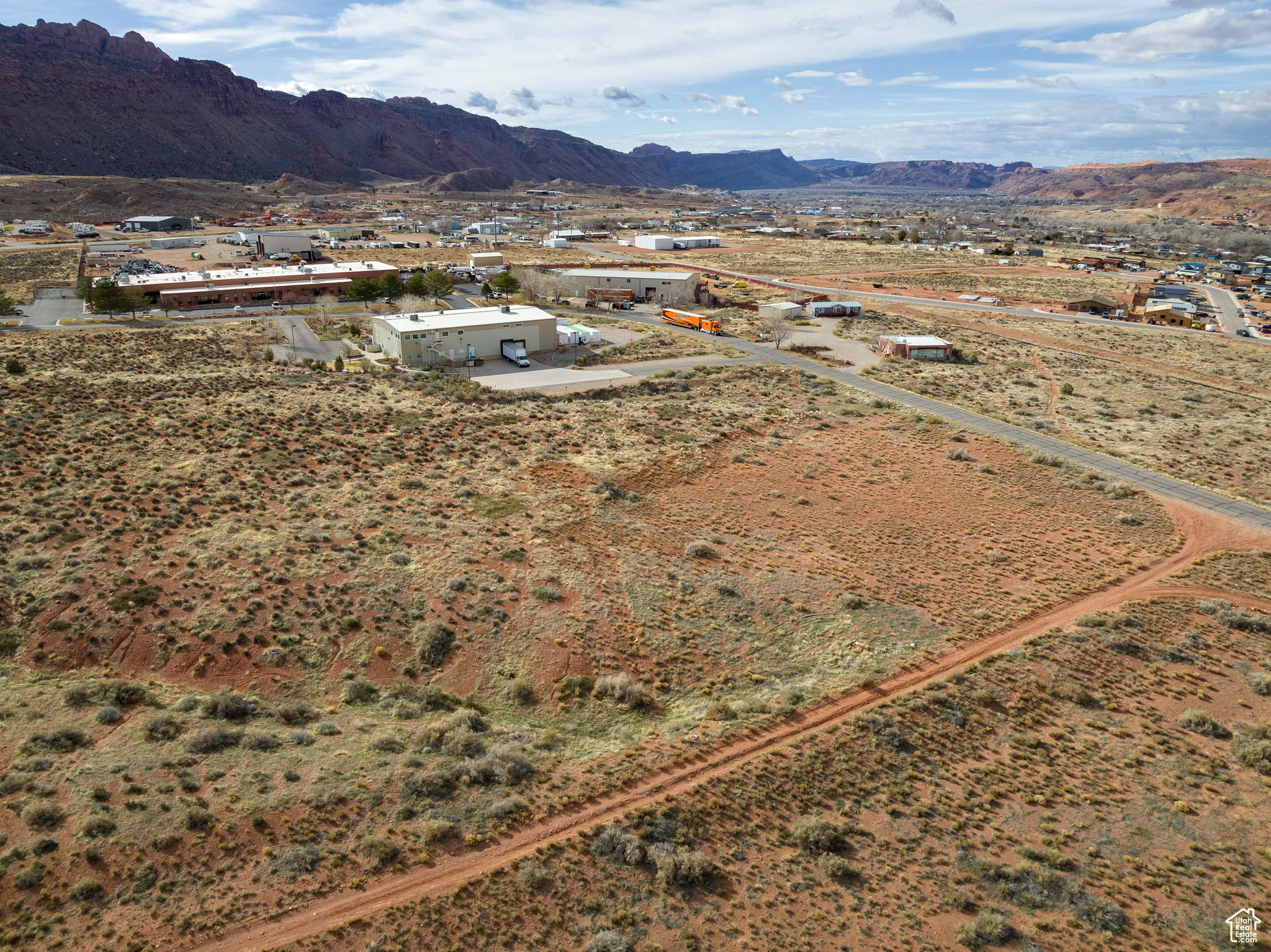 Aerial view of property and surrounding area with a mountain backdrop and rural landscape