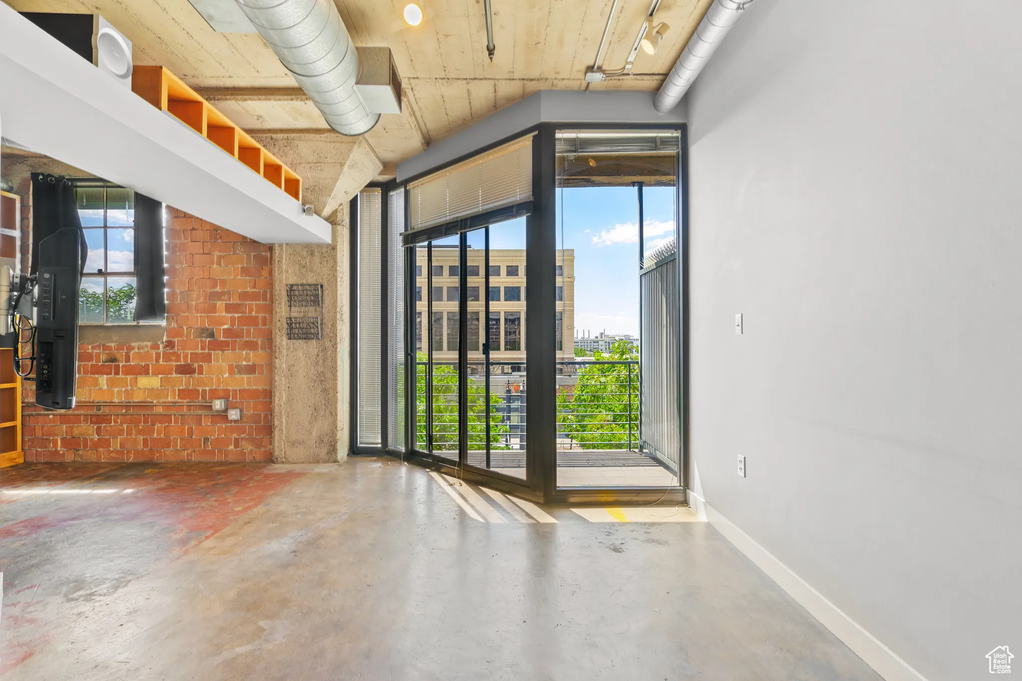 Living room with concrete floors and brick wall