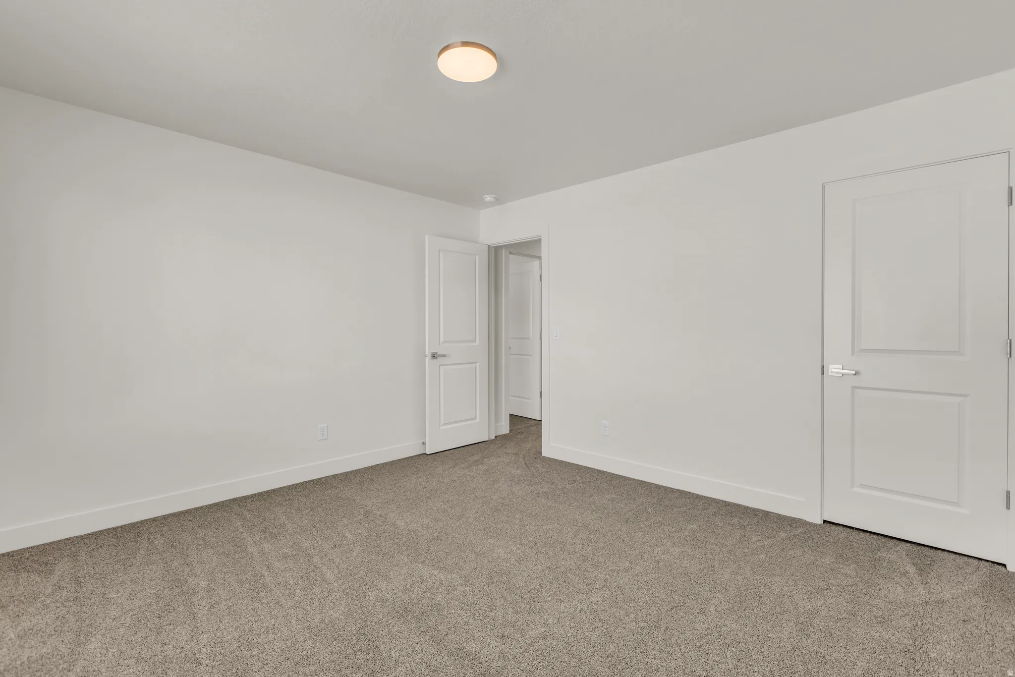 Unfurnished bedroom with baseboards and carpet flooring