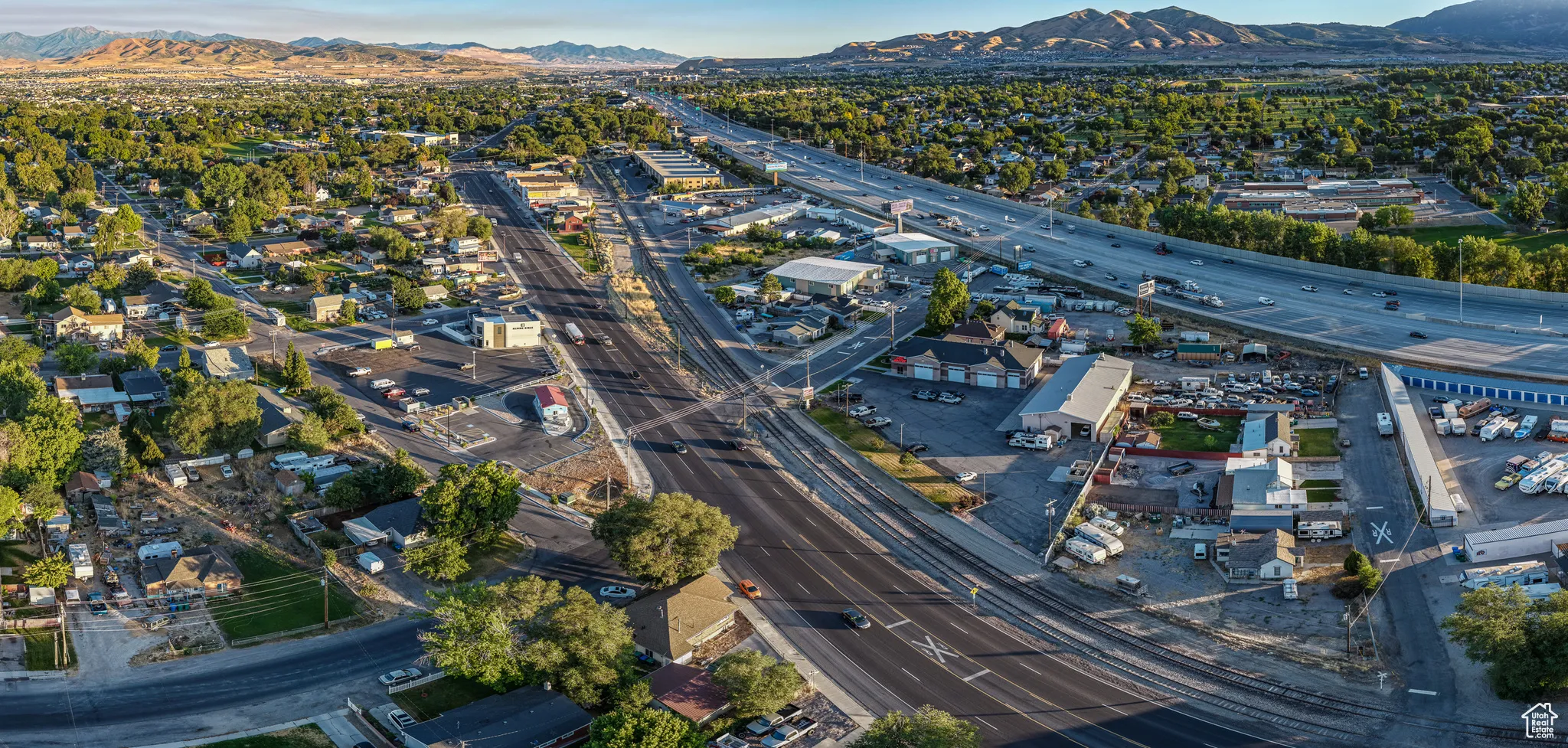 Aerial view of property's location featuring a highway and a mountain backdrop