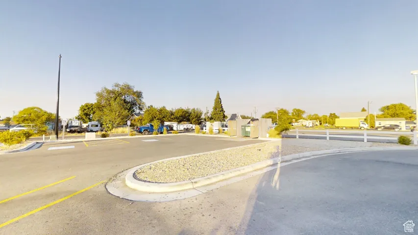 View of asphalt road featuring curbs and a residential view