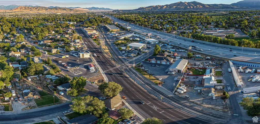 Aerial view of property's location featuring a highway and a mountain backdrop