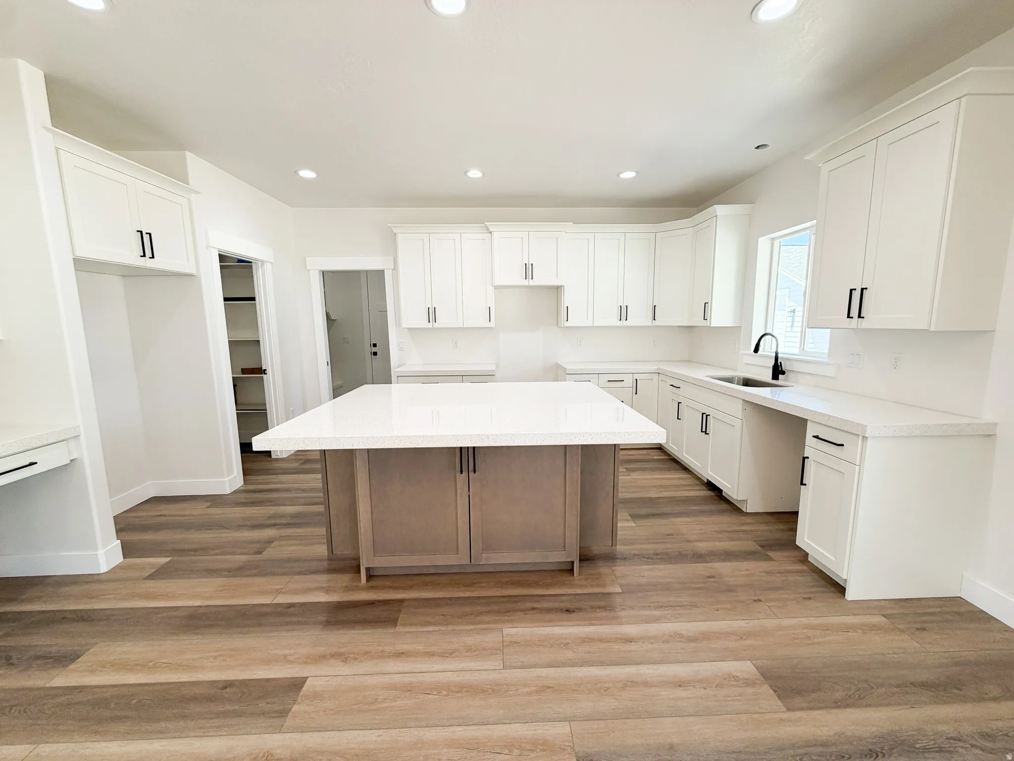 Modern kitchen featuring an expansive center island with integrated cabinetry