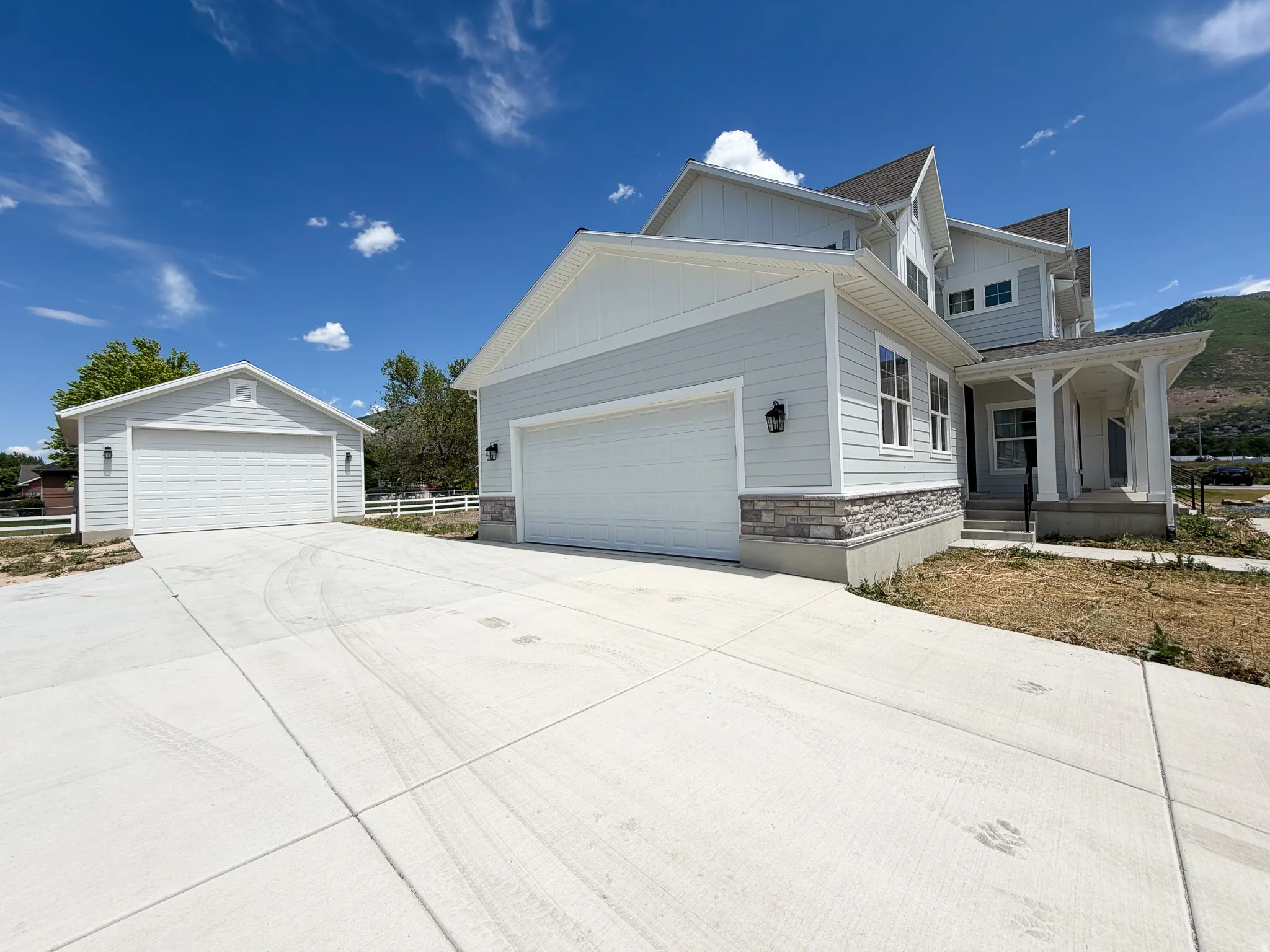 Light blue siding exterior with stone accents and a covered front porch