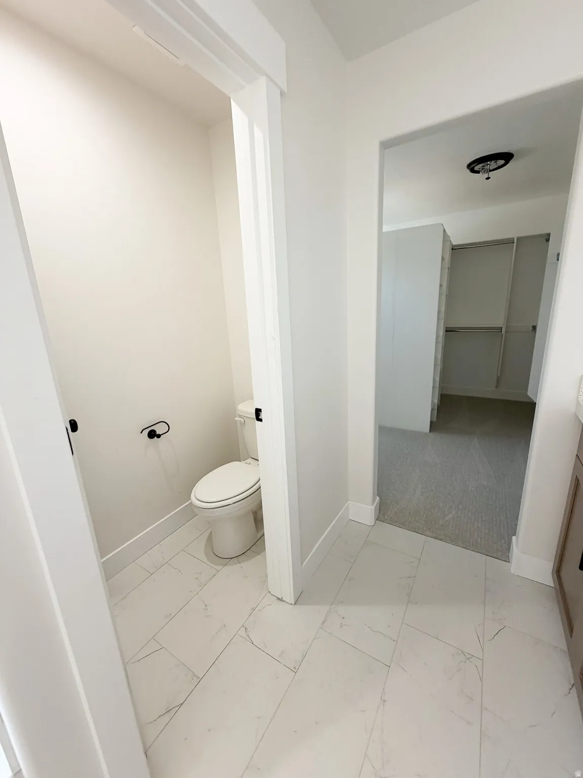 Porcelain tile flooring with veining detail throughout the space