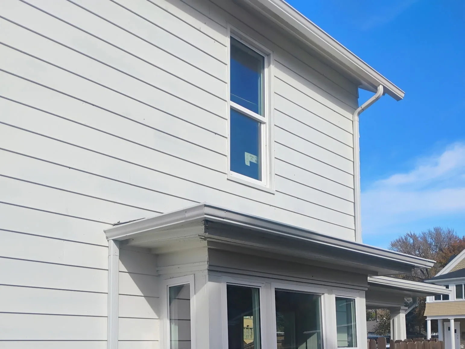 View of side of home featuring a wooden deck