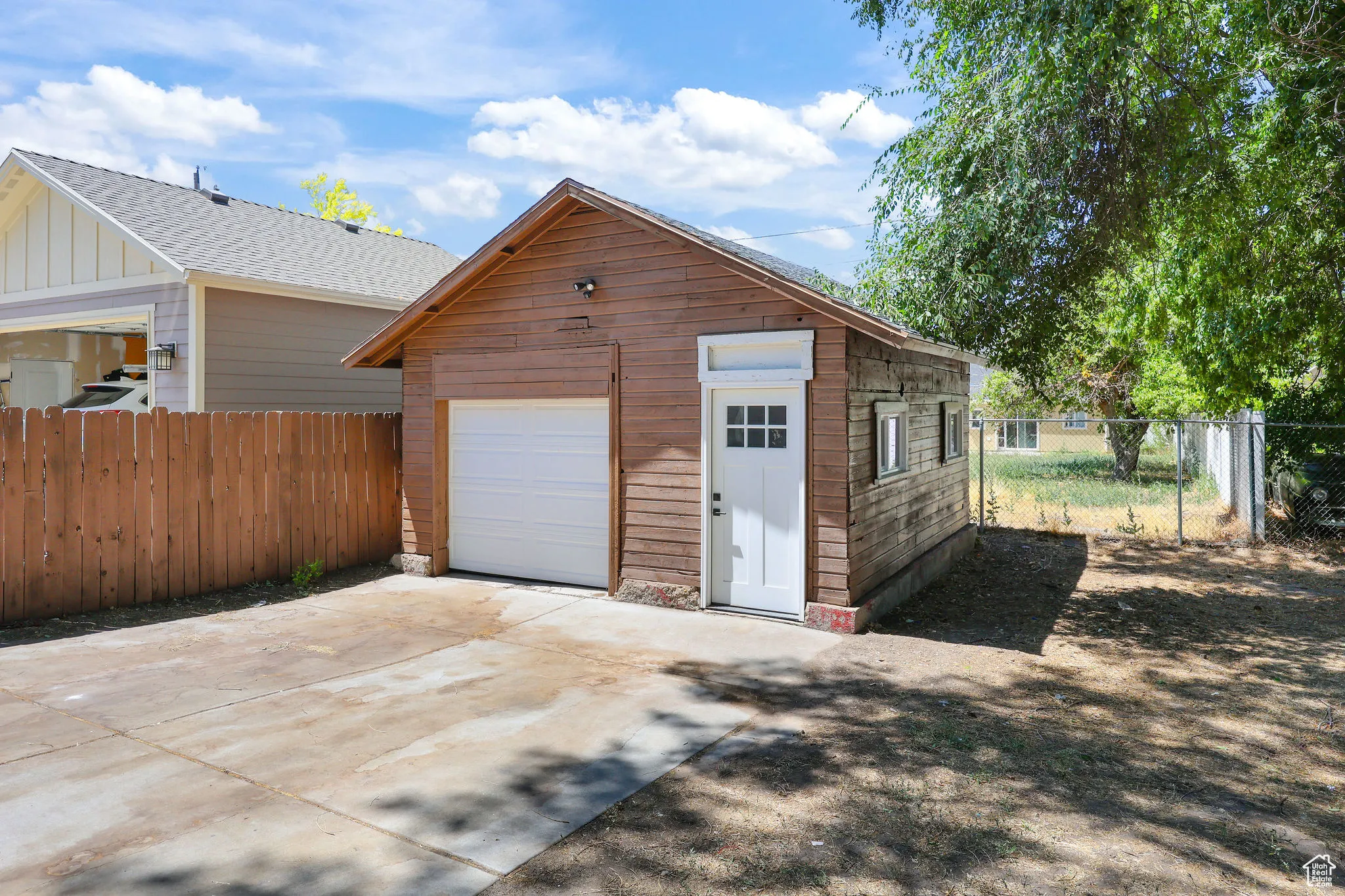 Garage featuring concrete driveway