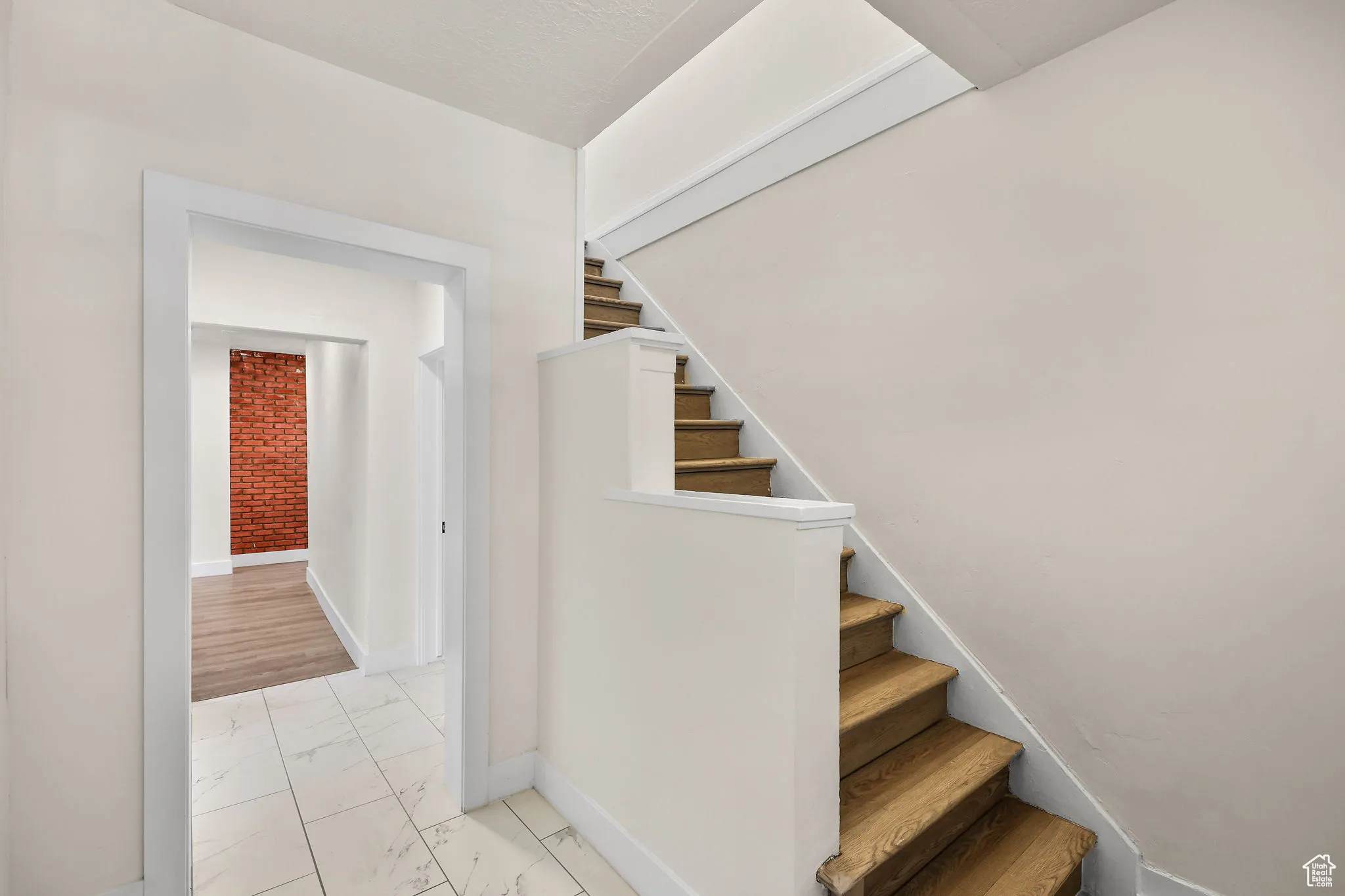 Stairs featuring baseboards and marble finish floors