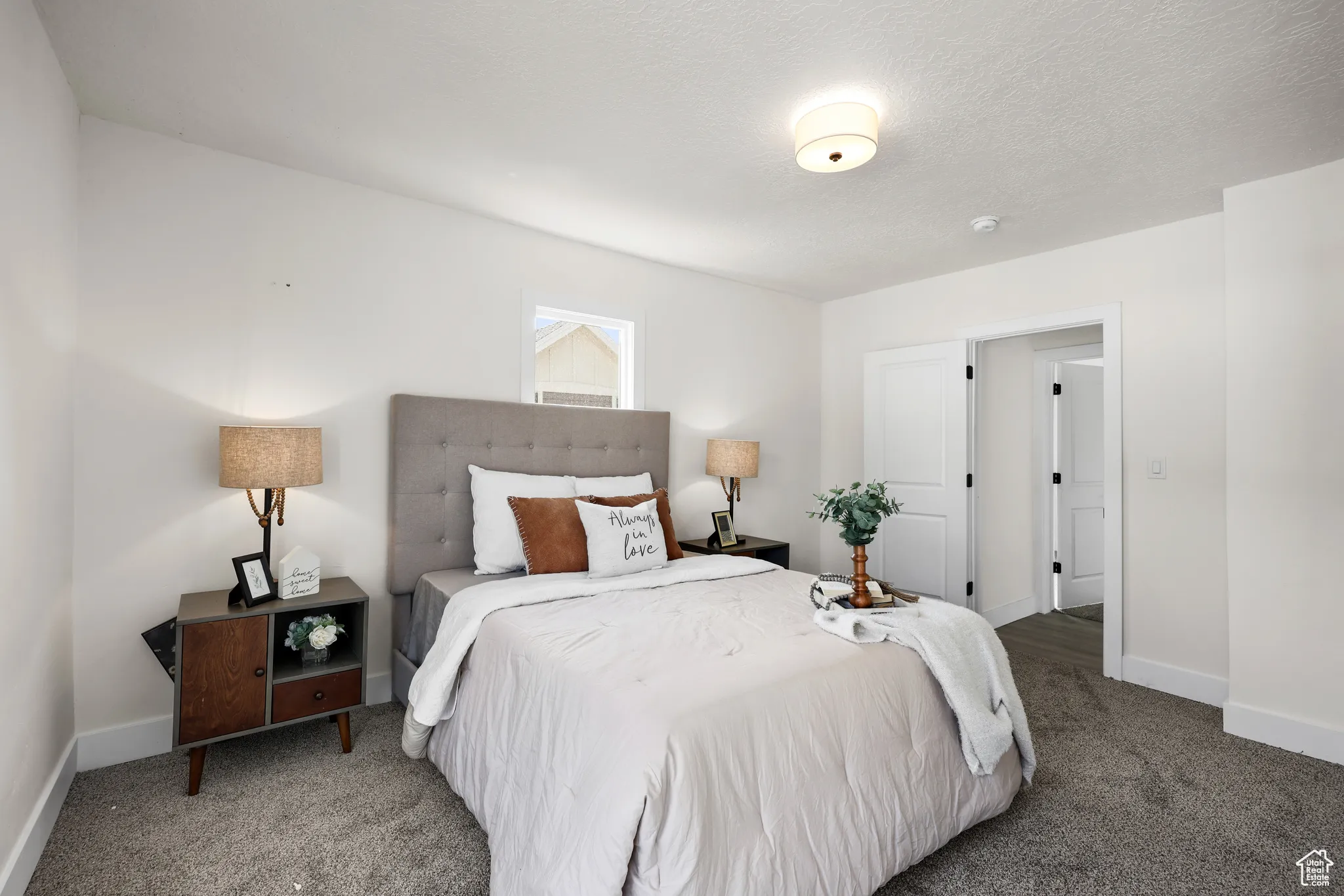 Bedroom with carpet floors and a textured ceiling