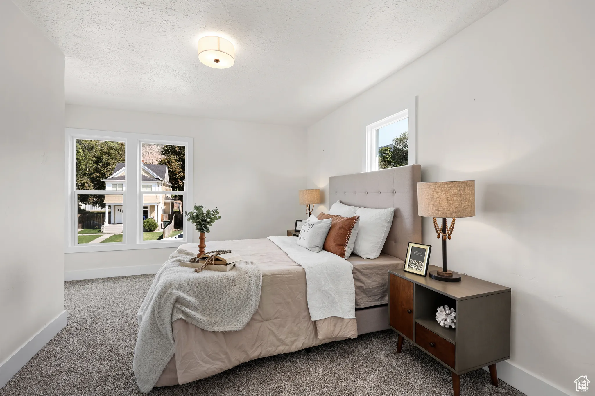 Bedroom featuring carpet floors and a textured ceiling