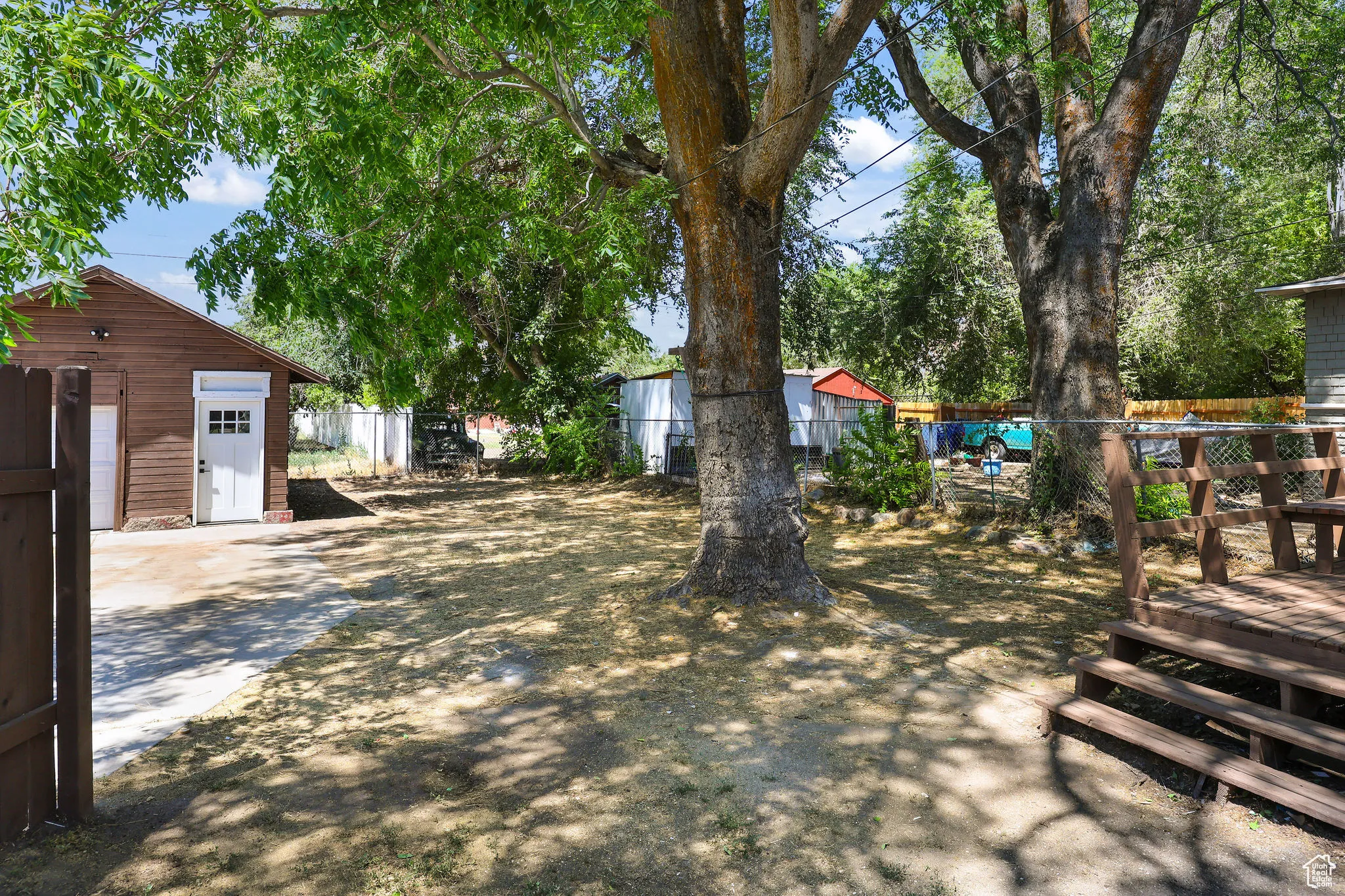 View of yard featuring an outbuilding and a deck