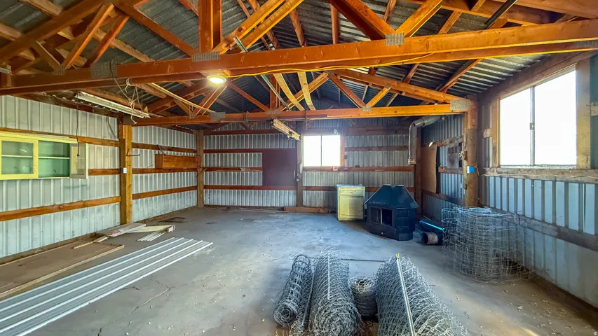 Detached Garage featuring metal wall and concrete flooring
