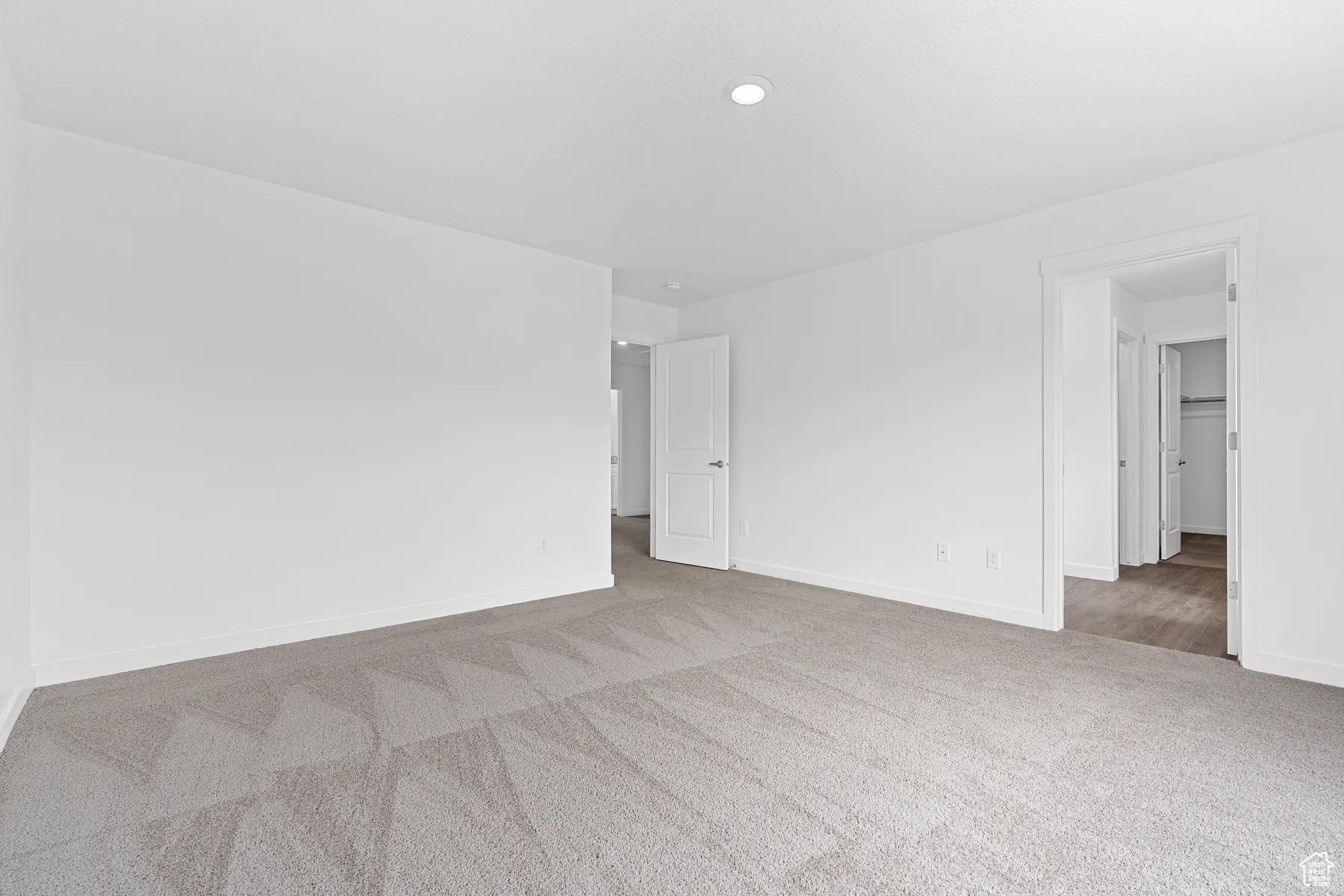 Carpeted empty room with baseboards