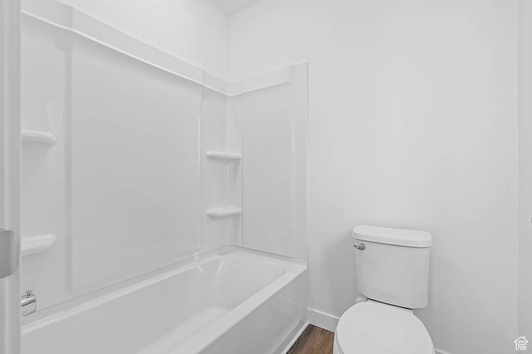 Full bathroom featuring toilet and  shower combination