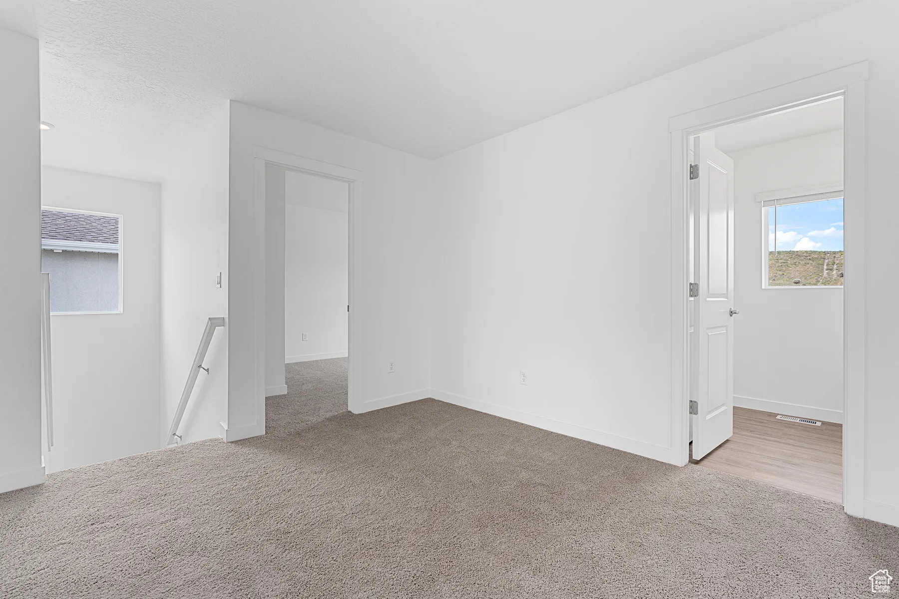 Carpeted empty room with baseboards