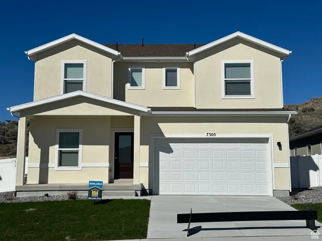 View of front of home featuring stucco siding, a porch, driveway, and a garage