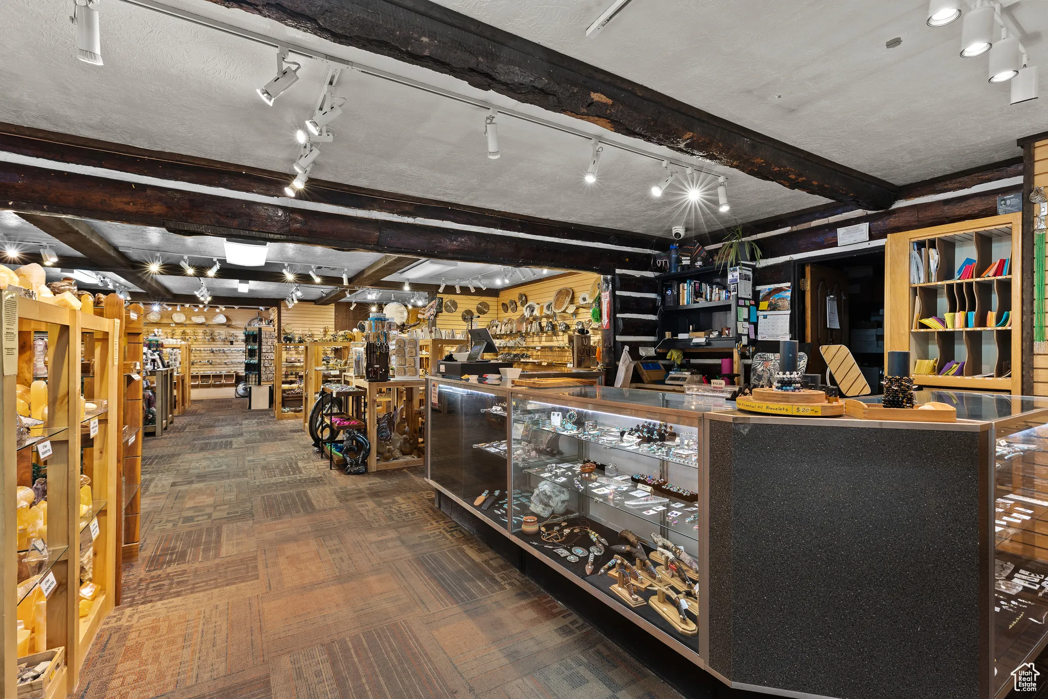 Misc room featuring beam ceiling, carpet, and track lighting