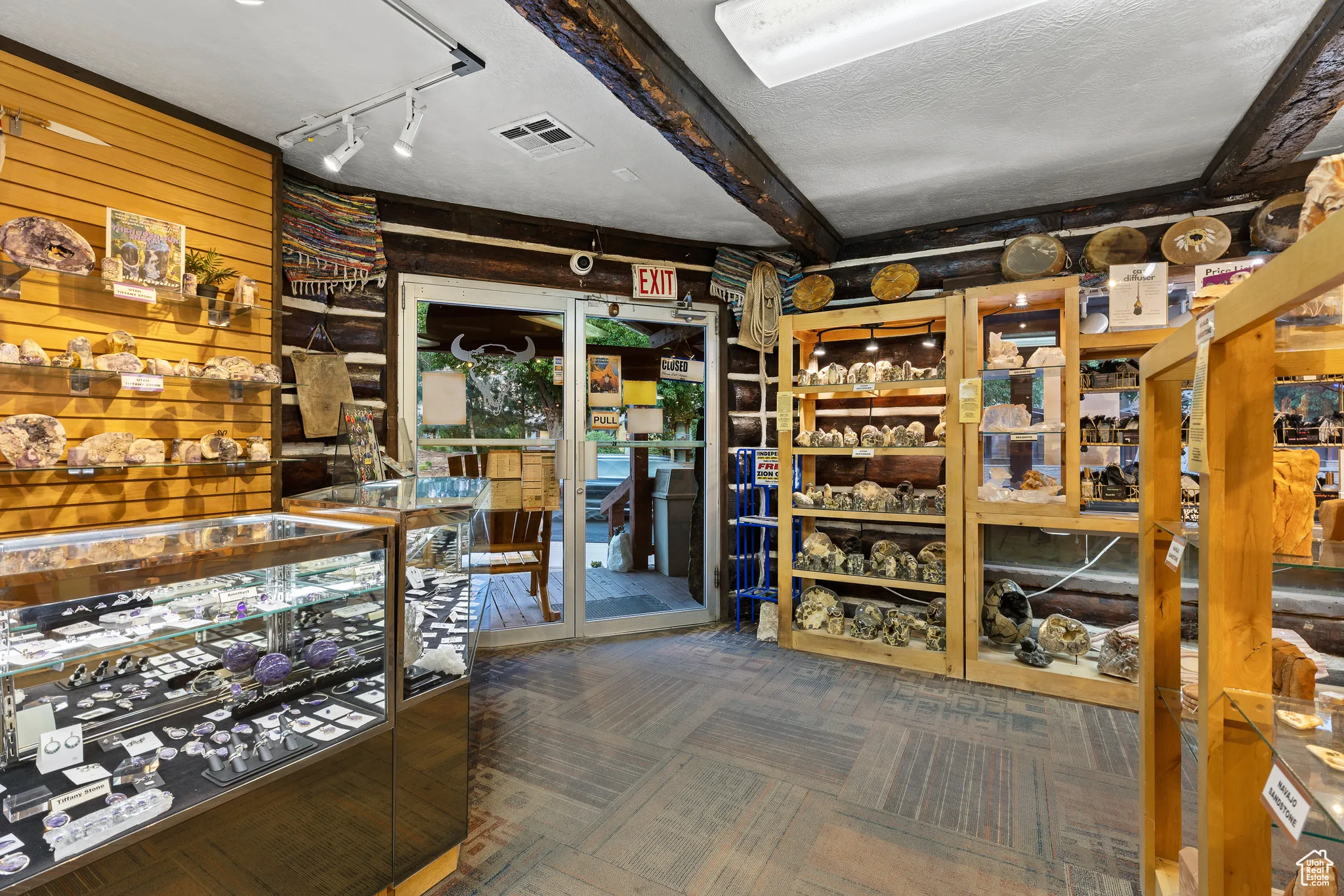 Wine room featuring carpet floors, wood walls, and track lighting