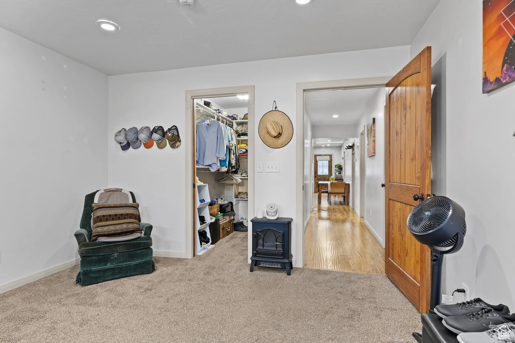 Living area with a wood stove, recessed lighting, and carpet