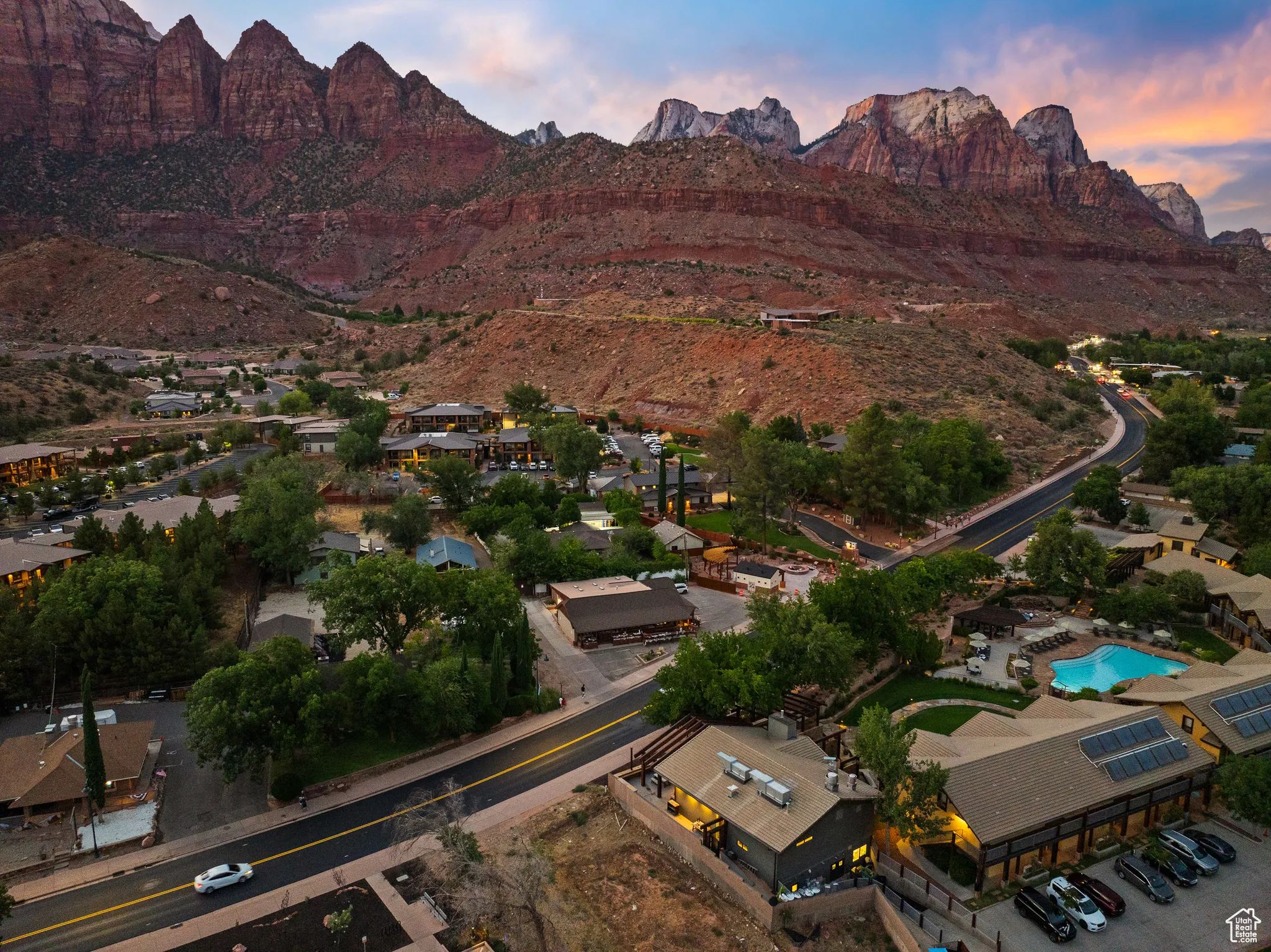 Aerial view at dusk of a mountain view and view of pool
