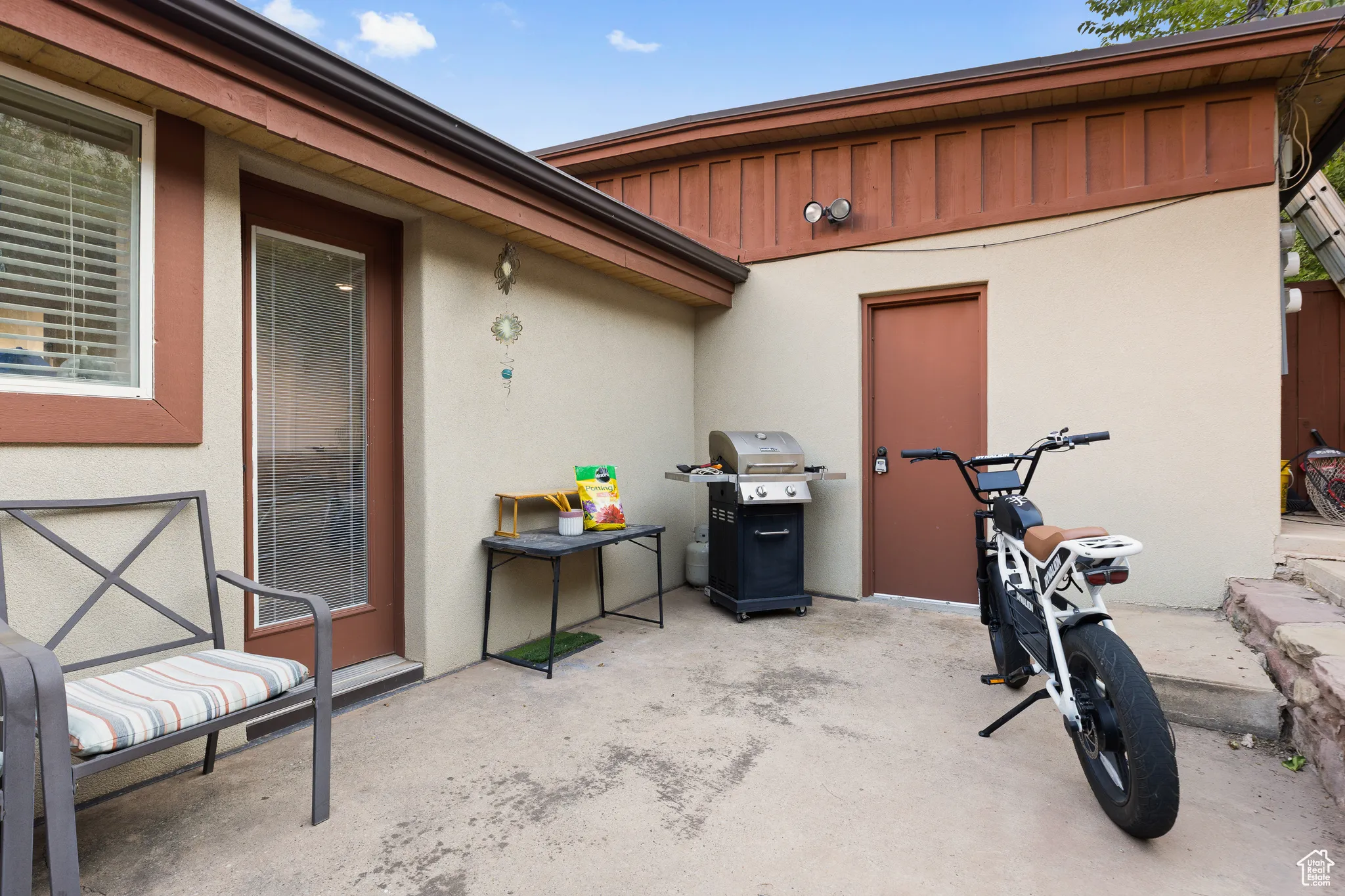 View of patio featuring a grill