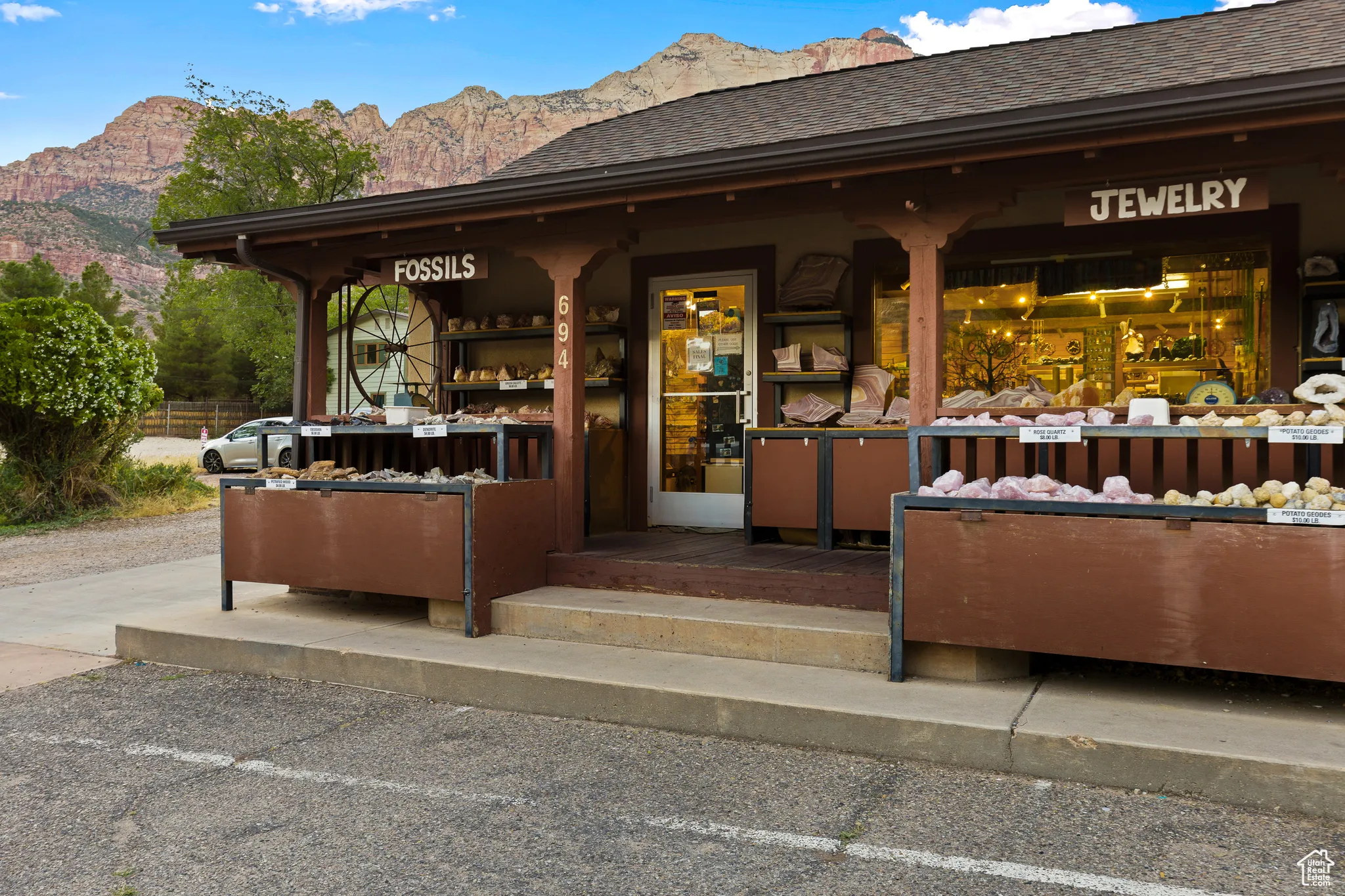 Doorway to property with a mountain view and roof with shingles