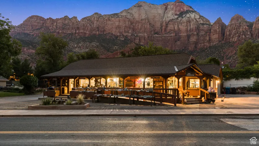 View of front facade featuring a porch, a mountain view, and a shingled roof