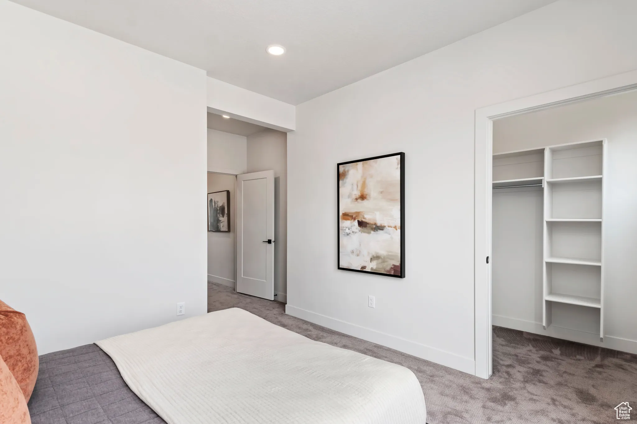 Bedroom with carpet flooring, a spacious closet, and recessed lighting