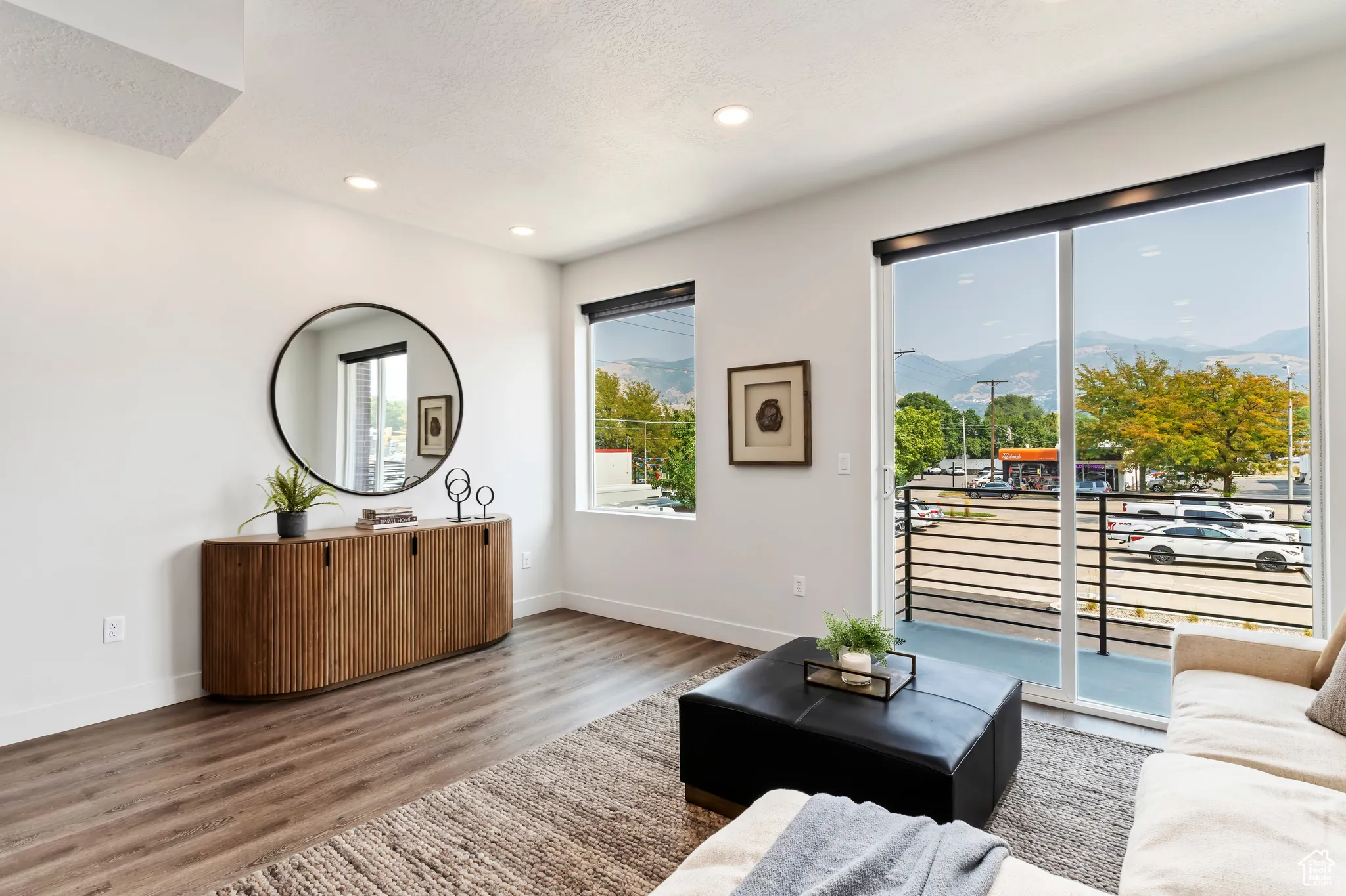 Living room with a mountain view, wood finished floors, recessed lighting, and a textured ceiling
