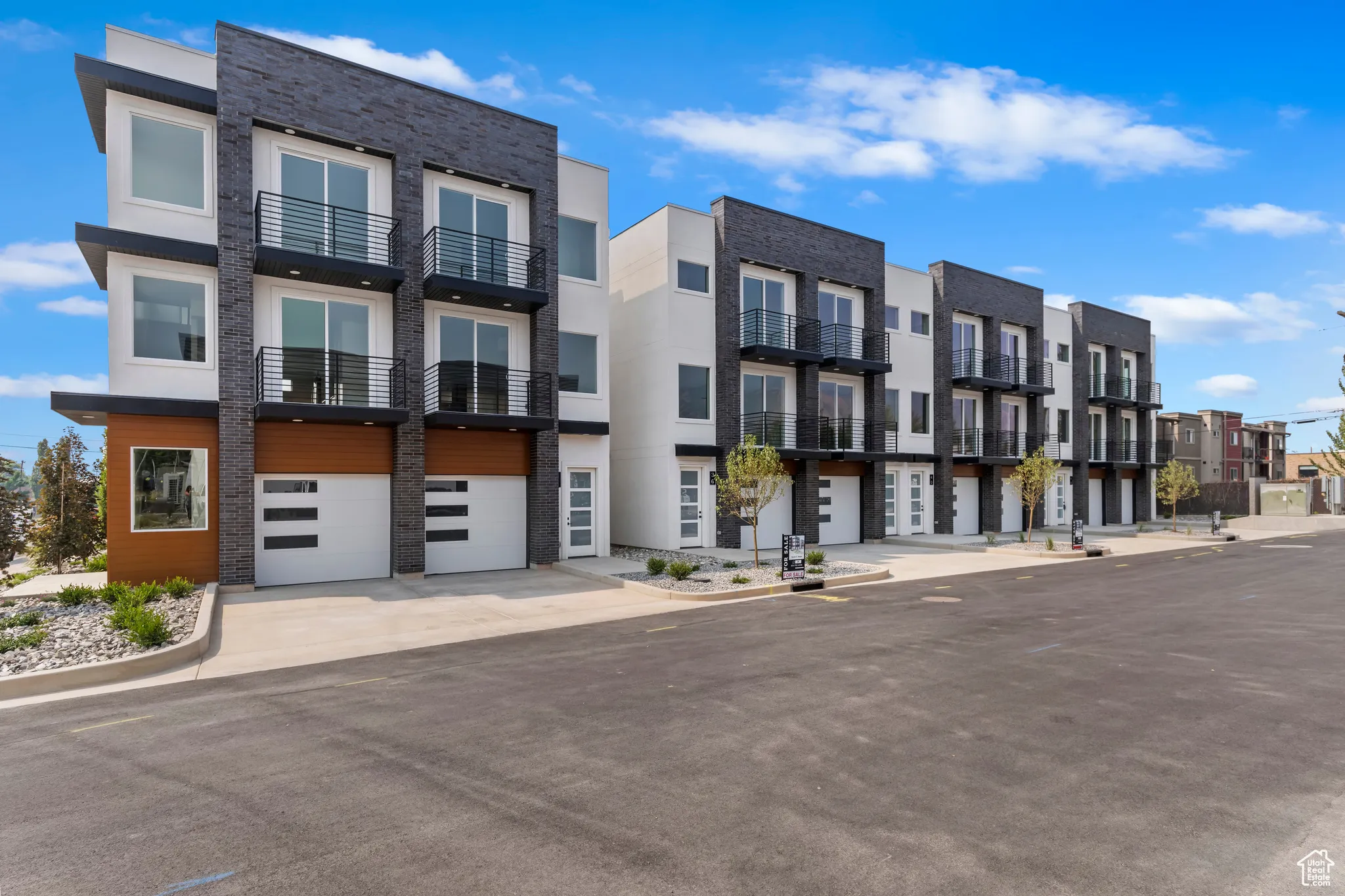View of property with a garage, a residential view, and driveway