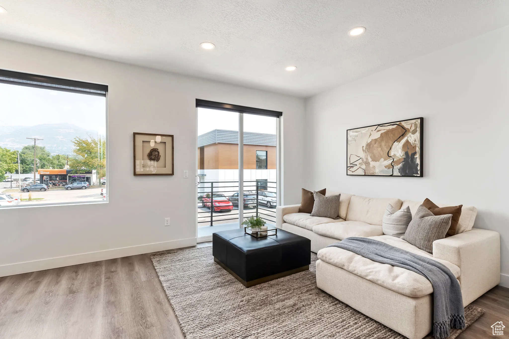 Living room featuring wood finished floors, recessed lighting, and a textured ceiling