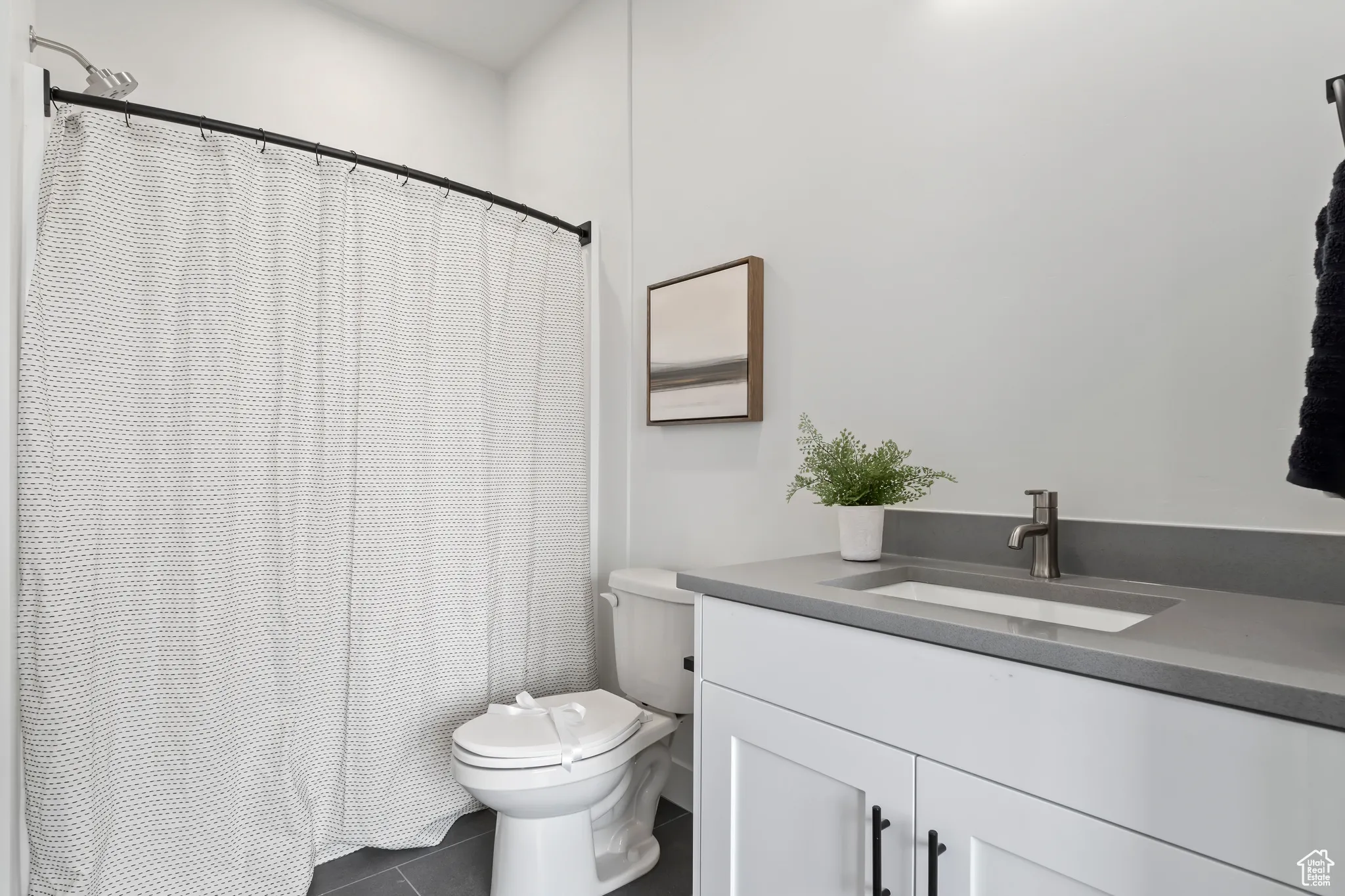 Bathroom featuring tile patterned floors, vanity, and a shower with curtain